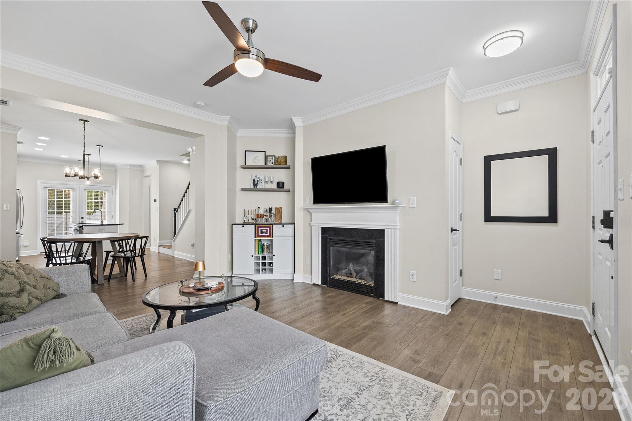 Welcome home to this move-in ready townhome in Lela Court, a charming community nestled among the tree-lined streets of historic Wesley Heights! Thoughtfully updated throughout, this home offers the perfect blend of modern upgrades and low-maintenance living in an unbeatable location. The bright and airy main level features an open-concept floor plan with tall ceilings, neutral paint, a cozy gas fireplace, and newer LVP flooring that continues up the staircase. The living space flows into a refreshed kitchen with granite countertops, stainless steel appliances, and painted cabinetry with updated hardware. Step outside to your fully enclosed private patio with stone pavers and a peaceful wooded backdrop, an ideal space for entertaining, dining or relaxing. Upstairs you’ll find new carpet throughout and a spacious primary suite complete with a walk-in closet and en suite bath. The second bedroom has a beautiful board and batten accent wall and offers flexibility as a guest room or home office. A conveniently located laundry closet includes a new washer and dryer, plus added storage. Major recent improvements provide peace of mind, including a new roof (2025), new HVAC system (2026), new dishwasher (2025), updated lighting and hardware throughout the kitchen and bathrooms, and new carpet upstairs (2025). Enjoy exceptional Wesley Heights lifestyle with Stewart Creek Greenway and Frazier Park just steps away, plus a scenic 15-minute walk along the greenway to Bank of America Stadium. You're also within walking distance of neighborhood favorites including Rhino Market, Town Brewing, and Pinky's, while the rapidly growing Thrift Road district is just minutes away which is the new home to the Front Porch CLT market! This home gives you the opportunity to own a truly move-in ready home at a great value in one of Charlotte's most dynamic and sought-after areas! 
**Seller is offering a $5,000 closing credit with an acceptable offer**