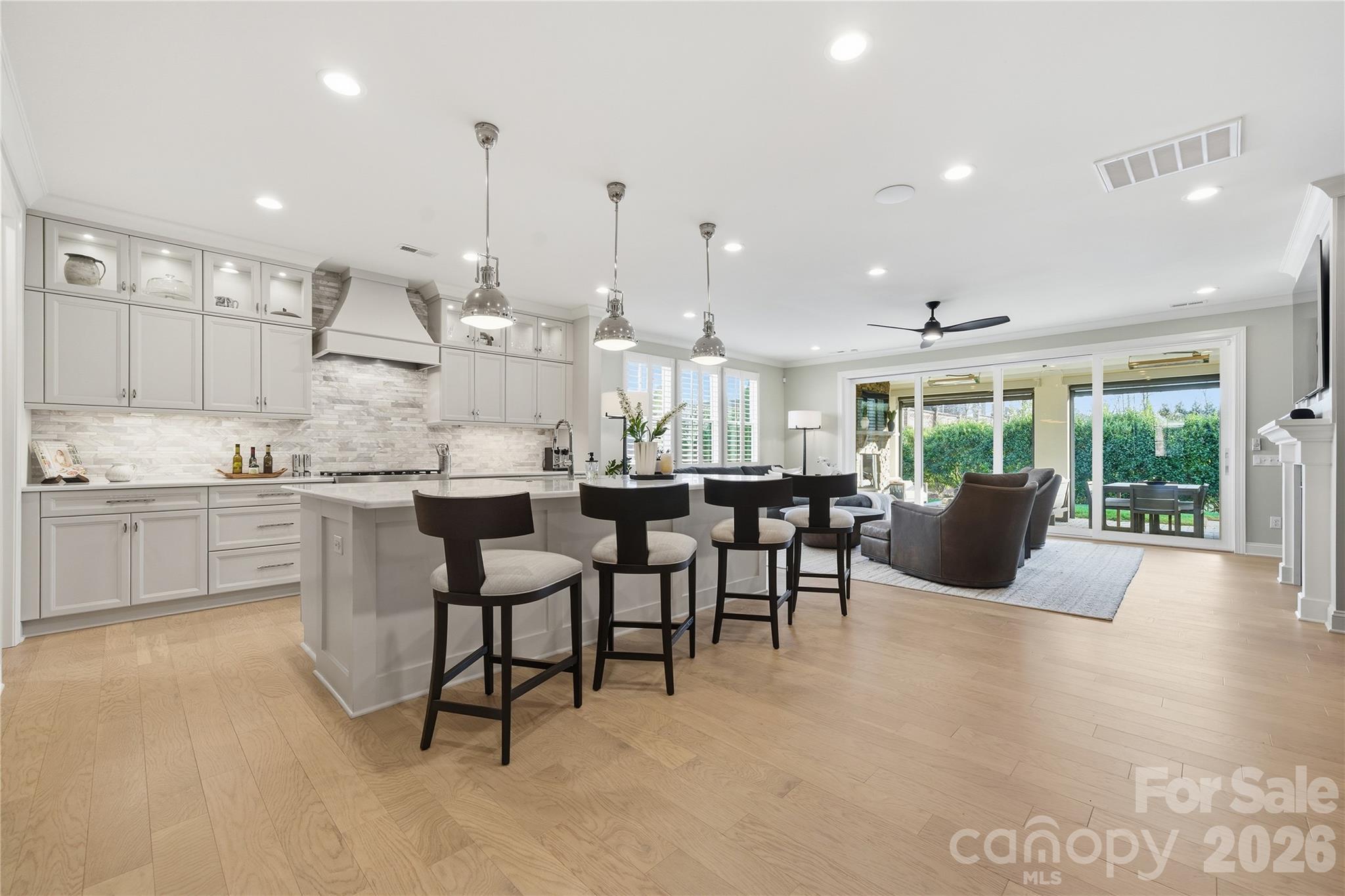 There is a certain kind of home that feels immediately, unmistakably right...a home that fits your life perfectly. This is that home.

From the moment you step inside, the home is designed to impress without trying too hard. Wide-plank white oak floors, curated premium finishes, and executive-level features set the tone for a space that feels both elevated and livable.

At the center of it all is a feature you won't forget: a dramatic 16-foot accordion glass wall that opens completely to a covered outdoor living room, equally suited for solitude or celebration. Stone fireplace, retractable screens, and ceiling heaters make this space work year-round. This is the room that changes how you live.

The kitchen is built for connection. A 10-foot quartz island anchors the space, complemented by custom cabinetry, a gas range, and a walk-in pantry that keeps everything within reach but out of sight. The main-level primary suite is a private retreat. Spa-inspired bath with dual shower heads, custom vanity, and integrated laundry. A separate guest suite on the main floor ensures visitors experience the same comfort and privacy.

Upstairs, every detail continues with intention. Each bedroom features its own ensuite, while a loft, media area, and dedicated office provide the flexibility today's work-from-home lifestyle demands.

And then there's the backyard. Intentionally low-maintenance, landscaped, and with pool potential! A local pool company has already designed a cocktail pool with water feature for this lot. Step from the covered outdoor living room to your own private pool and patio, or enjoy the space as it is. The Pavillon Pocket Park is steps away for morning walks or neighborhood gatherings.

All of this in a location that makes sense. Fort Mill School District, ranked #1 in SC. Minutes to Charlotte for work and dining, downtown Fort Mill, and Kingsley Town Center. Recreational outlets at the Anne Springs Close Greenway and Scenic Riverwalk Outdoors, Carolina Thread trails. Plus the lower taxes and cost of living that make South Carolina so attractive.

Come home to luxury. Live effortlessly. Move-in ready. The timing is yours.
This isn’t just a move—it’s a strategic upgrade in how you live.

1016 Thatcher Way is a rare opportunity in Arden Mill, the one your next chapter has been waiting for.

Full interactive 3D tour available. See media links. Pool proposal in MLS documents.