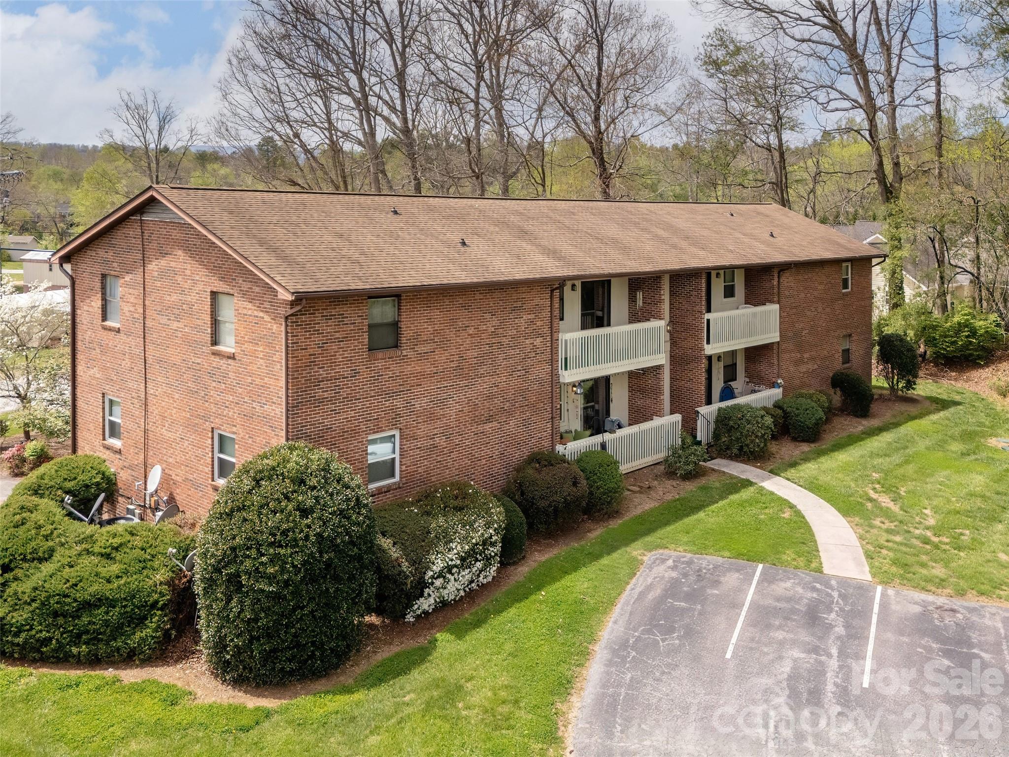 Enjoy a peaceful, low-maintenance lifestyle in the quiet Brookside Manor 55+ community, known for its spacious, well-kept grounds and serene atmosphere. This move-in ready condo offers both privacy and comfort, with wooded surroundings off the deck and mountain views out the rear windows. Inside, the home features an airy layout with notably large living spaces, including a generous living room, dining area, and a roomy kitchen with ample cabinetry and workspace. The primary bedroom includes a private bath and plenty of closet space, while two additional bedrooms provide flexibility for guests, hobbies, or a home office. The freshly painted interior provides updated colors and clean, well-maintained carpeting adds to the home’s inviting feel. Additional highlights include an in-unit washer and dryer, abundant storage throughout, and an extra-large one-car garage with additional storage space. Conveniently located near shopping and a short distance to Hendersonville and Asheville, this home offers a comfortable blend of space, convenience, and quiet community living.