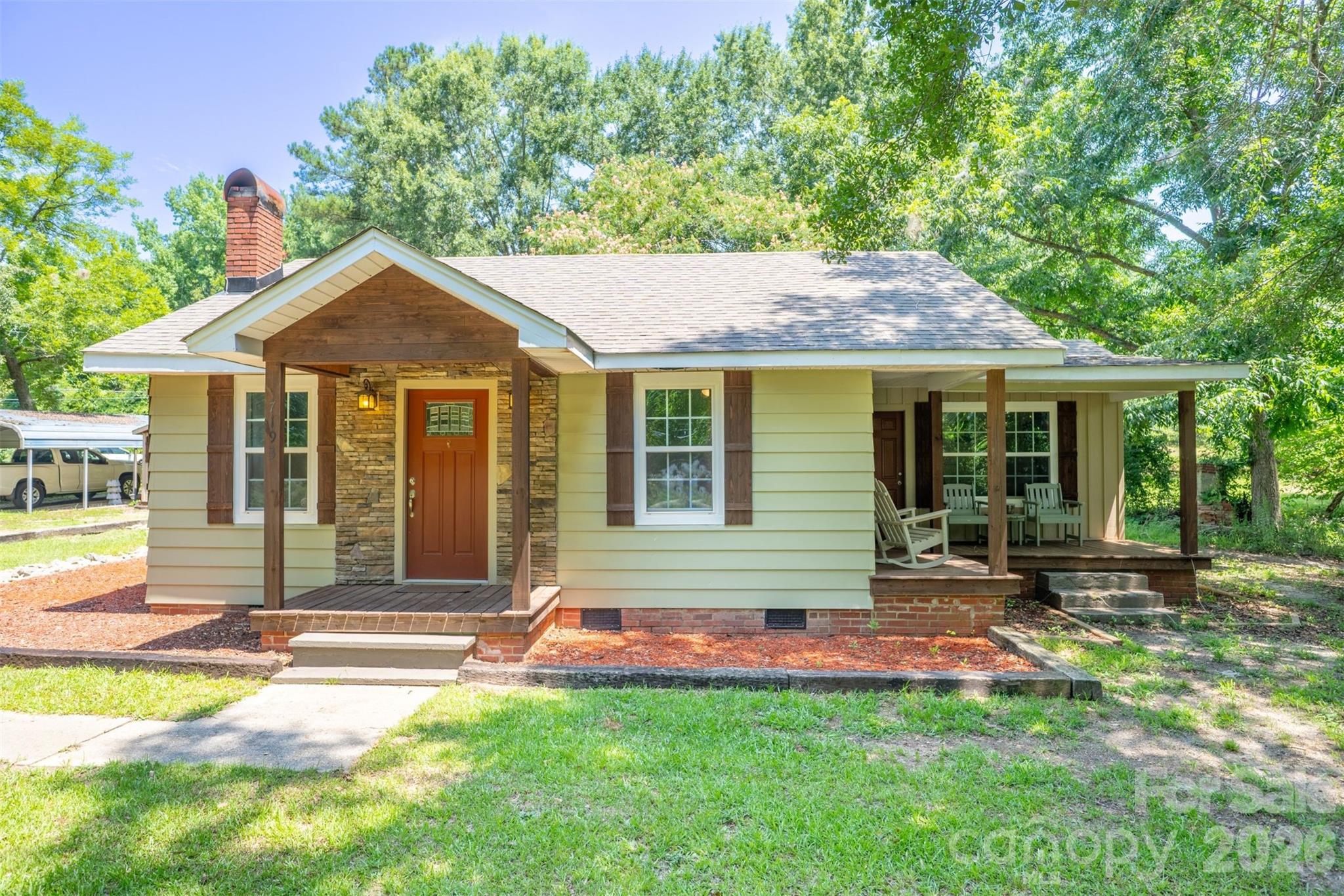 Charming, updated home on 1.9 acres just minutes from town. This adorable property features modern finishes throughout, including stone accents, granite countertops, tile flooring, and wood ceilings. The layout offers 3 bedrooms (with 2 tandem-style rooms) and a beautifully updated full bath with a tub/shower combo and a stylish barn-door entry. The centrally located bathroom provides easy access for all occupants and guests. The spacious laundry room offers potential for adding a second bathroom if desired. Outside, you’ll find a large workshop—ready for a little TLC but structurally solid and easily convertible into a nice 2-car garage—plus a 2-car carport shed. Set on a wonderful corner lot in a great area, this property combines character, land, and opportunity.  A beautiful stone fireplace in the living room is currently sealed but may be unsealed for future use.