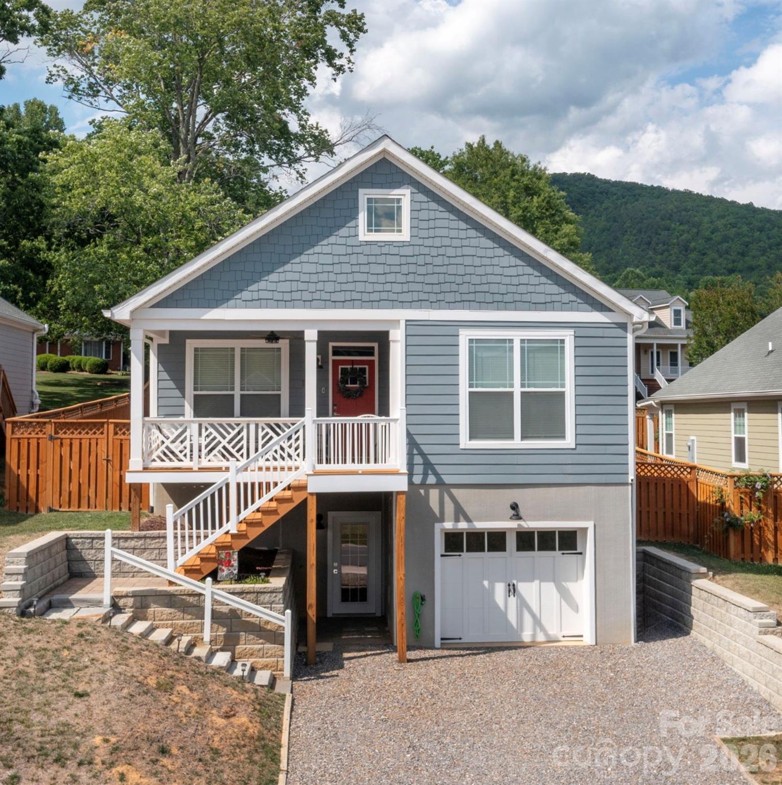 Rare Opportunity! Move-in/vacation rental ready home with long range Mountain Views! Fully furnished (with a few exceptions). Experience the ultimate mountain lifestyle in this exceptionally well-kept, move-in-ready home in the desirable new community of Padgett Place. Perfectly situated just 1.5 miles from historic Downtown Black Mountain and a quick 15-minute drive to Asheville, this property seamlessly combines small-town charm with modern convenience. Enjoy morning strolls on the neighborhood sidewalks or take your furry friend to the community dog park. A Designer's Touch & Turn-Key Ready. This home is being sold fully furnished (with just a few negotiable exclusions) and comes 100% rental-ready. Professionally styled by a certified interior decorator, every room exudes modern mountain elegance. All linens, bedding, towels, and essential supplies are included, alongside a fully stocked kitchen—allowing you to start hosting guests or move right in from day one! Thoughtful Layout & Premium Features. Main level offers an airy, open-concept kitchen, living, and dining area serves as the heart of the home. The chef's kitchen boasts a large island, granite countertops, stainless steel appliances, and soft-close cabinetry. The Primary suite features a generous walk-in closet and a luxurious ensuite bath with double sinks and a custom tile shower with frameless glass doors. Two additional bedrooms and a full bath complete the main floor. The lower level offers an additional separate bedroom and full bath ideal for a private guest suite, a dedicated home office, or a separate homestay setup or living room/den. Unmatched Outdoor Living, take in the stunning, year-round long-range mountain views from either the covered front porch or the private backyard oasis. The outdoor space has been beautifully upgraded with: A fully fenced-in yard for pets and play. An oversized stone paver patio perfect for dining alfresco. A dedicated firepit area for cozy evenings under the stars. Ample storage & practicality, never run out of space with an oversized 1-car garage and a fully floored attic providing massive storage potential. Investor Note: Short-term rentals are permitted per community restrictions, making this a rare, lucrative, and completely seamless opportunity in this market.
