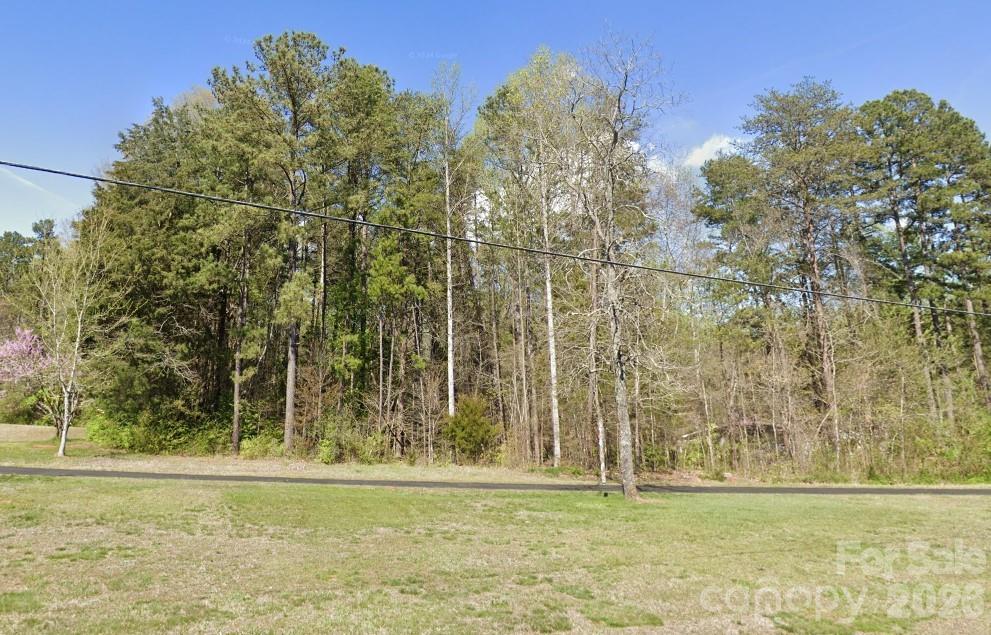 Location location location! Just outside of City Limits. Insert dream home here or possibly build multiple homes. This property offers over 2 acres of beautiful land in the heart of Mooresville between Charlotte HWY 21 & Mecklenburg HWY 115. Just a short drive to Lake Norman, Downtown Mooresville or Huntersville. Sold AS IS. The driveway in place belongs to this property and there is no easement connecting to the neighboring property. The property was subdivided so each address could have its own driveway.