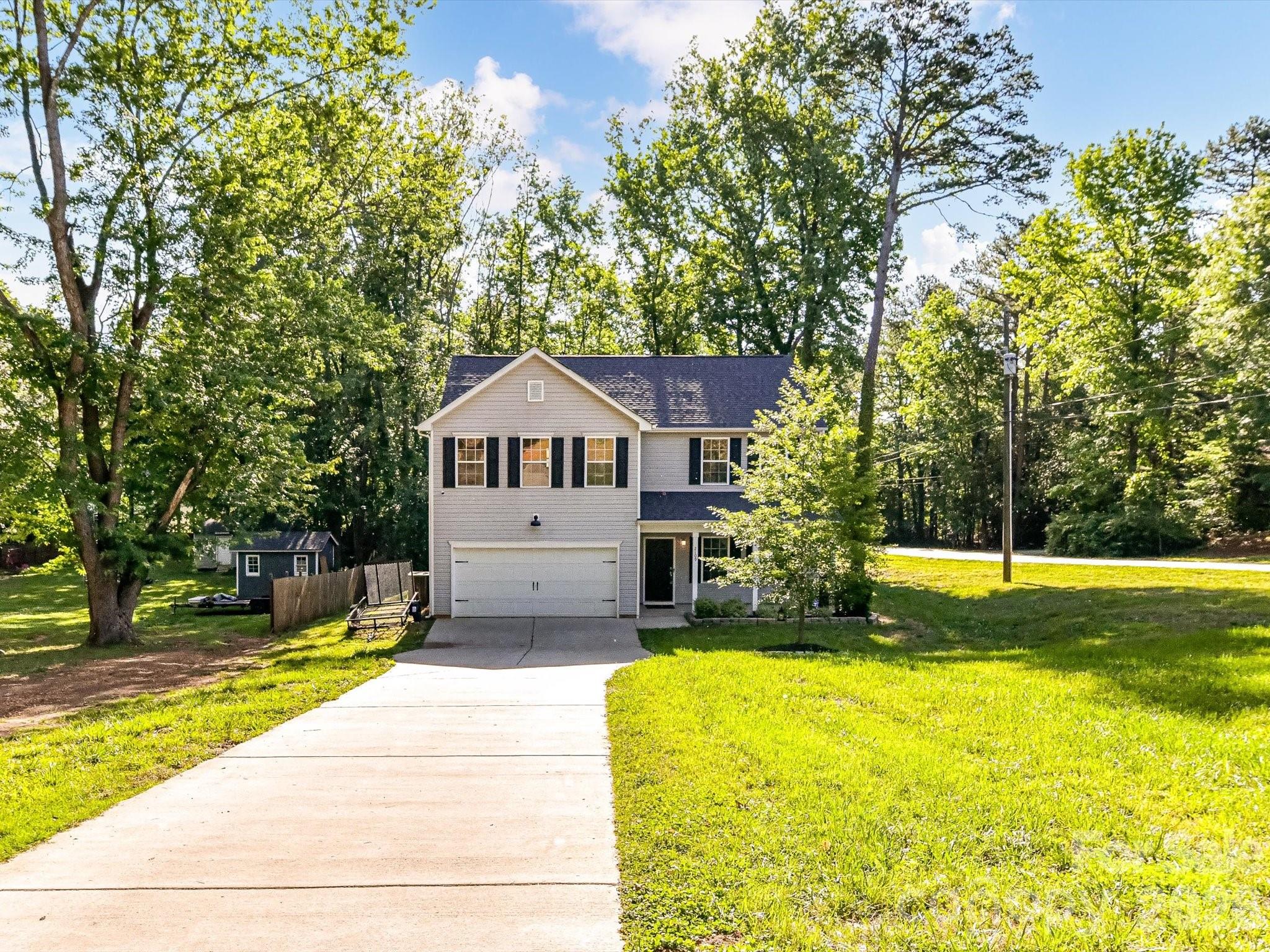 Welcome home to this beautifully maintained newer construction home situated on a spacious half-acre corner lot with no HOA! Conveniently located close to town, schools, shopping, dining, and entertainment, this two-story home offers the perfect blend of comfort, style, and functionality.

Step inside to a welcoming entryway featuring a convenient half bath and soaring ceilings that open into the spacious living room. The open-concept layout flows seamlessly into the kitchen, complete with a large granite island featuring an overhang perfect for bar stools, ample cabinetry, and a walk-in corner pantry — ideal for everyday living and entertaining alike.

Upstairs, you’ll find all four generously sized bedrooms along with a conveniently located laundry room. The spacious primary suite features elegant tray ceilings and a relaxing ensuite bathroom complete with a garden tub, stand-up shower, and dual vanity with his-and-her sinks. The secondary upstairs bathroom also offers double sinks, providing added convenience for family and guests. The additional bedrooms offer plenty of space for family, guests, or a home office setup.

Enjoy peaceful mornings on the covered front porch with plenty of room for rocking chairs, or unwind out back in the fenced-in backyard featuring a wooden back porch ideal for relaxing evenings, grilling, or enjoying the above-ground pool during warm summer days. Additional features include a paved driveway and attached two-car garage, offering plenty of parking and storage space. With its corner lot location and thoughtful layout throughout, this home truly has it all!