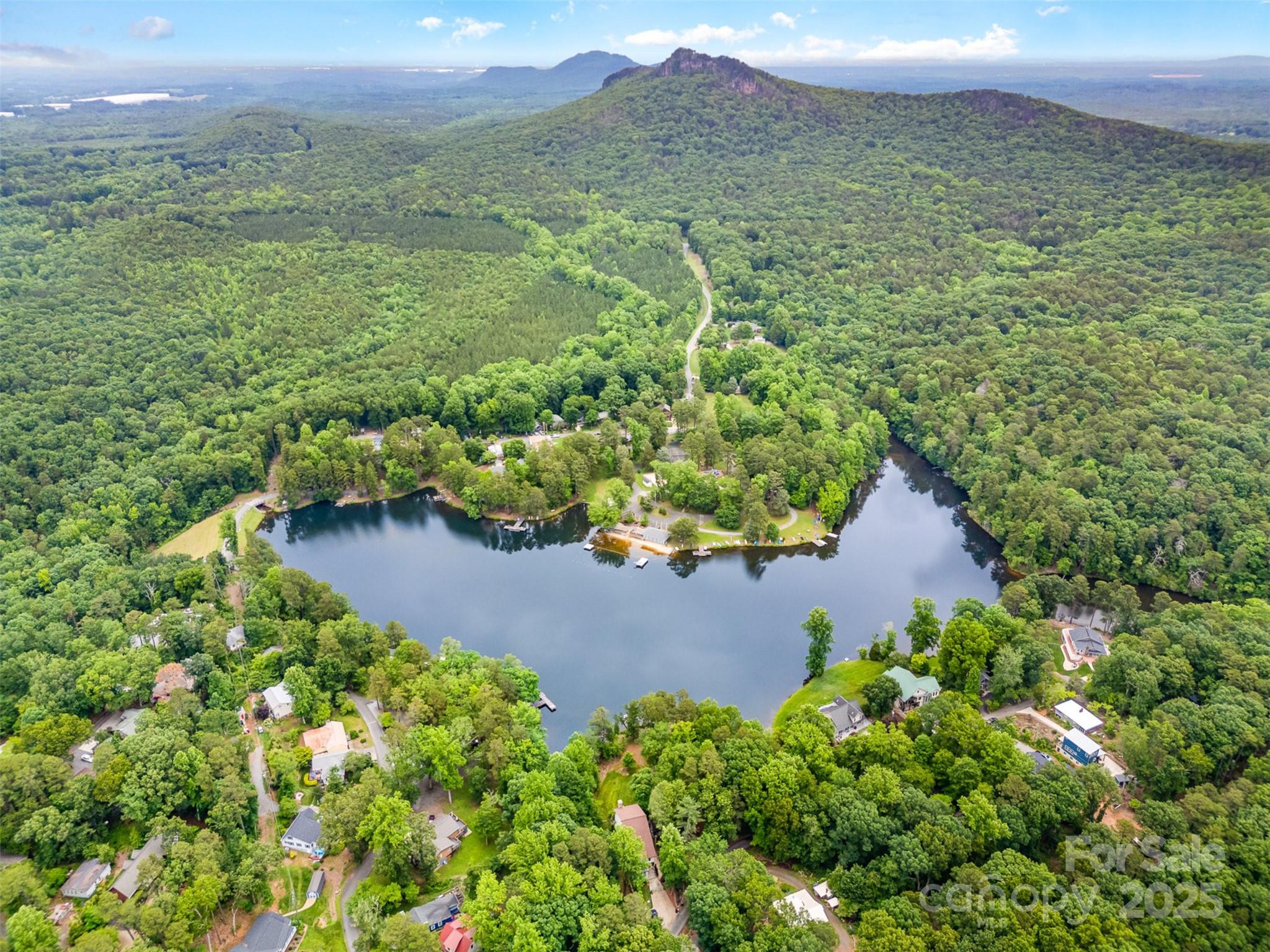 Tucked away in a peaceful private community on Lake Montonia, this 3BR/2BA home offers exclusive lake access with a sandy beach, picnic area, and calm waters perfect for swimming or paddling. The property sits on a beautiful, wooded lot surrounded by protected land from Crowders Mountain State Park, ensuring privacy and natural beauty that will never be developed. Inside, the home offers a solid structure and generous space, ready for a thoughtful renovation to maximize its full potential. Outdoor enthusiasts will love having hiking, rock climbing, fishing, and breathtaking overlooks just minutes away via the Pinnacle and Ridgeline trails. A unique chance to enjoy quiet lakeside living with endless access to nature.