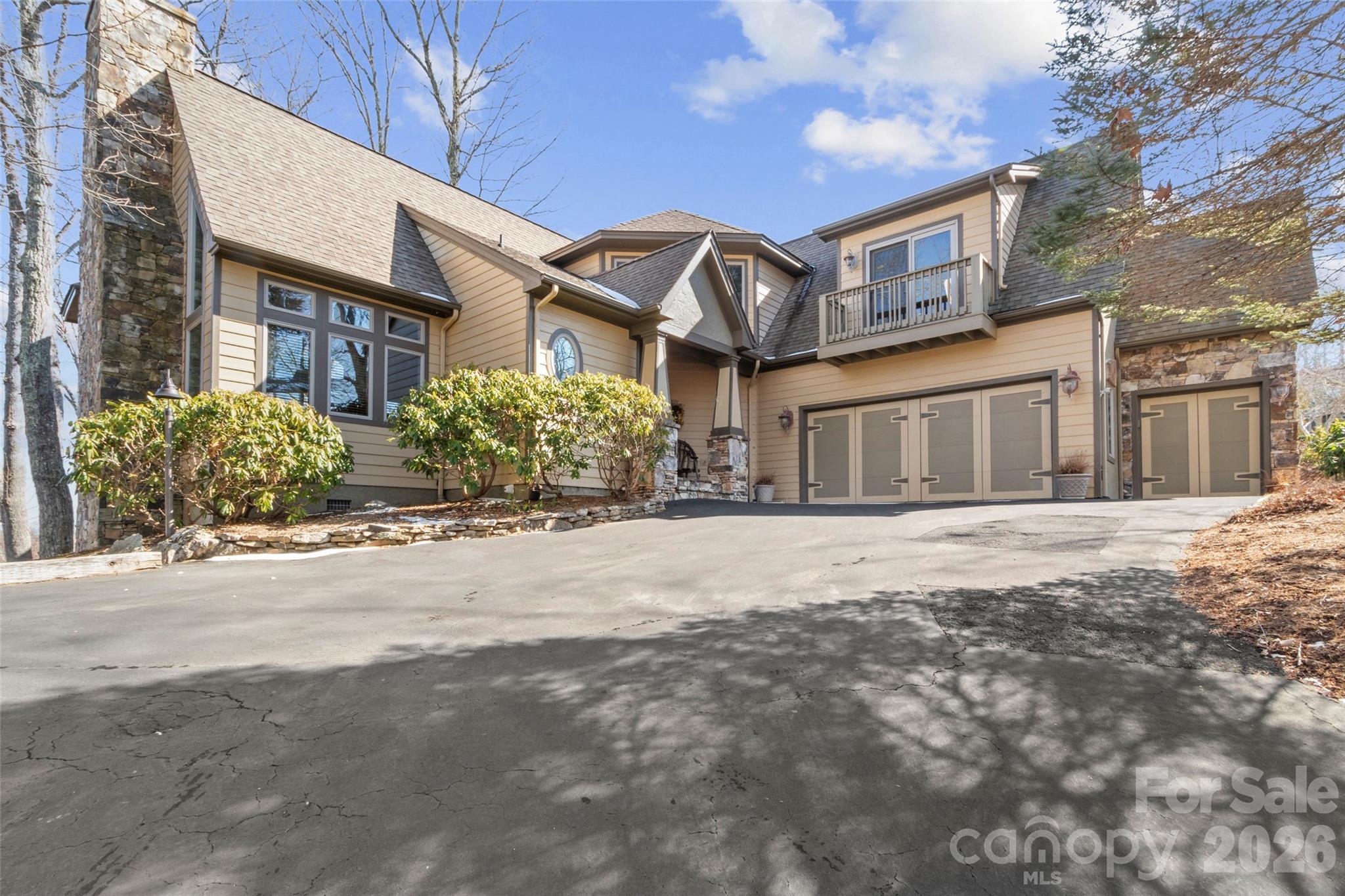 Nestled in the peaceful and private Spring House Drive neighborhood of MOUNTAIN AIR, this beautiful custom home offers year-round, long-range mountain views and unforgettable sunrises each morning. Thoughtfully designed for comfort and convenience, this residence provides main-level living with a spacious primary suite, while two additional bedrooms and bathrooms are located upstairs—along with flexible space ideal for a den, office, or even a fourth bedroom. Step inside to an open great room featuring soaring vaulted knotty pine ceilings, a stunning floor-to-ceiling stone fireplace with built-in cabinetry, rich hardwood floors, and a wall of Pella windows that flood the space with natural light. The adjacent dining area flows seamlessly into the kitchen, which is equipped with granite countertops, wood cabinetry, and stainless steel appliances—perfect for everyday living or entertaining. Enjoy crisp mountain air and spectacular views from the expansive outdoor deck, ideal for gatherings or quiet moments surrounded by nature. Additional highlights include a brand-new gas furnace installed in 2025 and the option to purchase a curated list of furniture and furnishings outside of closing. You have a front-facing, two-car garage with a separate golf cart garage for easy access. All property owners enjoy hiking trails, seven parks on the property, and access to the highest runway east of the Mississippi. Exclusive Mountain Air club amenities are available with a separate membership, offering access to golf, dining, fitness, and more. Don’t miss this rare opportunity to own a turnkey mountain home in one of Western North Carolina’s premier gated Communities.