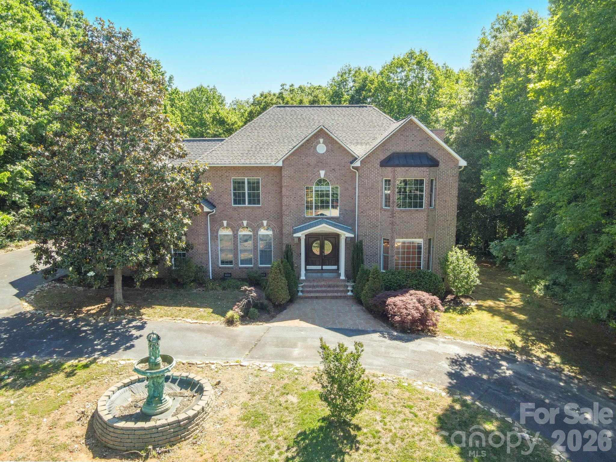 Architectural masterpiece showcasing exceptional craftsmanship, timeless elegance, and attention to every detail. This brick 4BR beauty offers an impressive blend of luxury, comfort, and thoughtful design. A grand foyer with sweeping staircase welcomes you inside, where rich hardwood floors flow throughout both levels.The chef’s kitchen is designed to impress with gorgeous granite countertops, tile accents, and  stainless appliances. Enjoy entertaining in the formal dining room with stunning wood inlaid flooring, or gather in the sunny breakfast area overlooking the private deck and spacious backyard—perfect for pets, play, or relaxing evenings outdoors. Large scale GR with gas log FP had glass doors leading the the deck with the removable outdoor kitchen. The luxurious primary suite is a true retreat, entered through double wooden doors. Primary bath with a jetted tub, separate shower and water closet, dual marble-topped vanities with carved wood cabinetry, and generous his-and-her closets. Bed #2,#3,#4 access the hall bath that is equally impressive with marble finishes and another jetted tub. A massive bonus room provides endless possibilities for recreation, media, fitness, or hobbies. Additional highlights include a 2026 heat pump for the main level, wireless electronic thermostats, full sensored sprinkler system, and an impressive lighted fountain. This remarkable “smart home” offers the perfect combination of sophistication, functionality, and move-in-ready convenience. The house  has architectural features that proudly command attention. Private cul-de-sac location. This property is within 1/2 mile of a voluntary agriculture district.