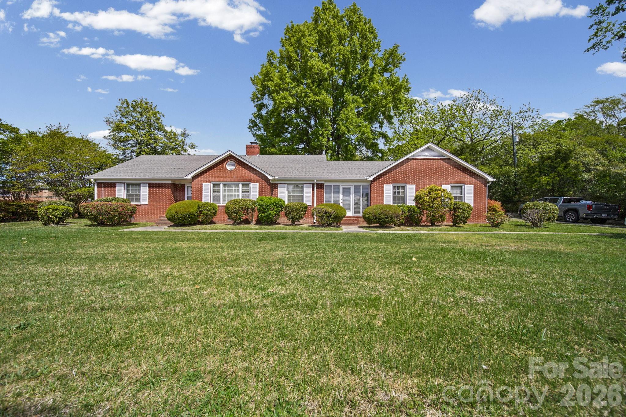 PRICE IMPROVEMENT.  Well-maintained brick home situated on approximately 0.49 acres with excellent Highway 74 road frontage in Marshville, NC. Built in 1949, this inviting one-story residence blends classic character with versatile living space.

The home features 2 bedrooms and 1 full bath, along with two separate living rooms—each with its own fireplace—offering flexible options for relaxing or entertaining. The property has been cared for over the years and reflects true pride of ownership.

An enclosed breezeway connects the main home to a spacious bonus/office area. The enclosed garage, complete with a fireplace and built-in bookcases, provides additional living or workspace potential and could easily serve as a home office, den, or bonus room. A dedicated storage room is also attached for added convenience.

Step outside to enjoy the fenced backyard, perfect for pets, gardening, or outdoor gatherings.

Zoned TMU (Transitional Mixed Use), this property offers exceptional flexibility for residential, retail, and/or commercial use—making it a unique opportunity for homeowners, business owners, or investors alike. With its prime Highway 74 frontage and adaptable layout, the possibilities are endless.