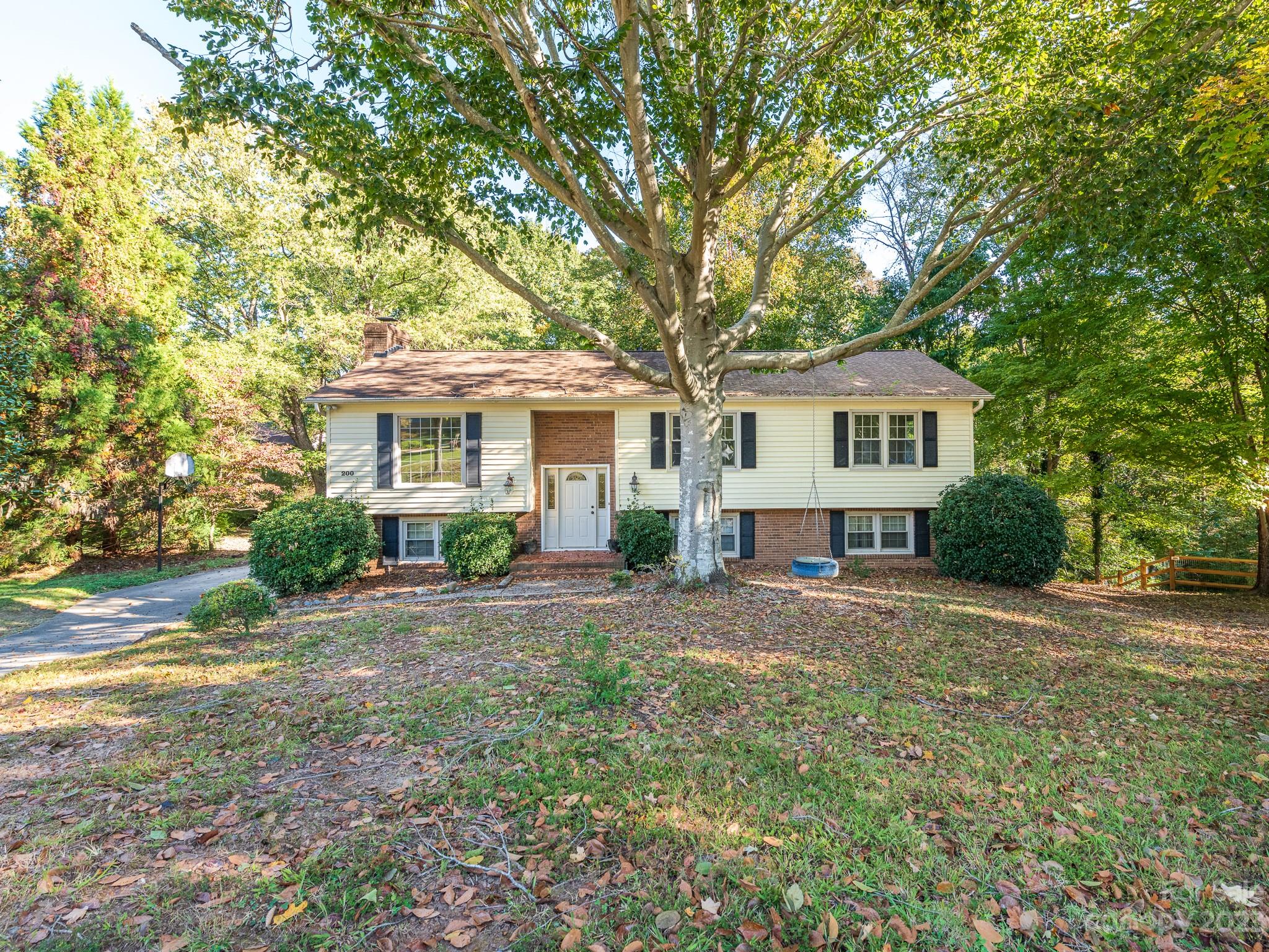 Spacious and Picturesque cul-de-sac split-level home w/ multi-tiered entertainment deck overlooking a lush & private backyard. Home is located inside I-485 just minutes from the Ballantyne area and Matthews. Stunning curb appeal welcomes you in to a bright living area. Wood plank flooring throughout main living areas including dining room that leads to kitchen. Open bar area creates semi-open plan from dining to kitchen. Entire home is flooded with natural light, including the 5 bedrooms! Primary bedroom on main level with attached full bath. 2 additional bedrooms plus full hall bath ideal for family & guests. Downstairs find open living space with white brick fireplace and side wall built-ins for storage. Full bathroom plus 2 bedrooms could be used as flex/office space, playroom etc. Incredible back deck options from every level of the home overlook the huge backyard filled w/ mature trees and multiple landscaping options. Incredible location with countless opportunity! Must See!!