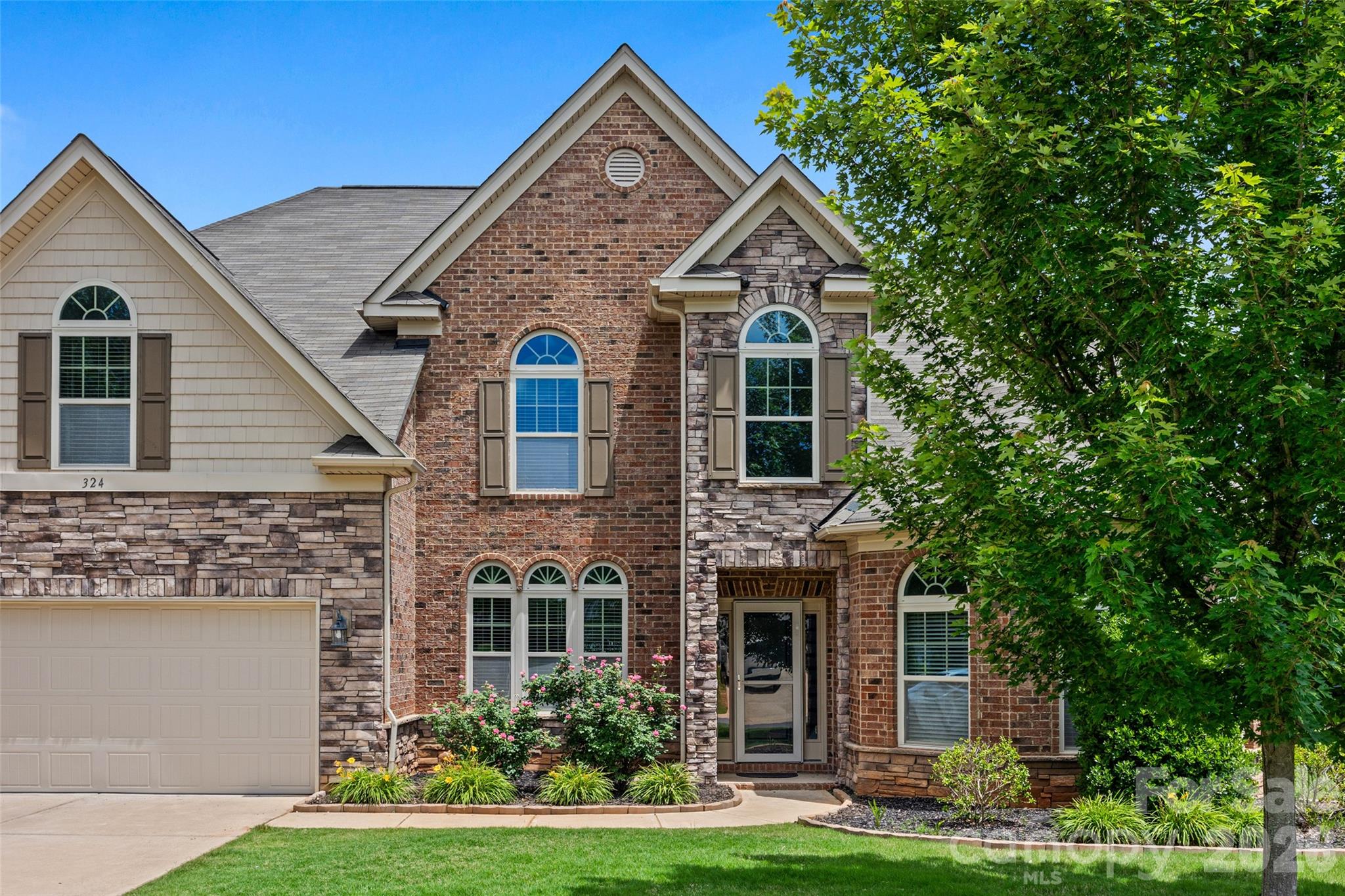 Stunning 4-Bedroom, 3.5-Bath Full Brick Home in Clover, SC.  This well-maintained 3,659 sq. ft. home offers 4 bedrooms, 3.5 baths, and two bonus rooms. The open layout features a primary suite on the main level with a tray ceiling, sitting area, and spa-like bath. One upstairs bedroom has an ensuite and could be used as a second primary.  The chef’s kitchen boasts stainless steel appliances, a gas cooktop, granite countertops, tile backsplash, bar seating, and ample storage with pull out lower cabinets, flowing into the great room with a coffered ceiling and gas fireplace. A formal dining room with wainscoting leads to a butler’s pantry, while a vaulted office provides a quiet retreat. Upstairs offers three spacious bedrooms and two flexible bonus rooms. The private backyard includes a covered and extended patio, with property lines extending beyond the fence and privacy trees. Minutes from the Lake Wylie  and Field Day Park.