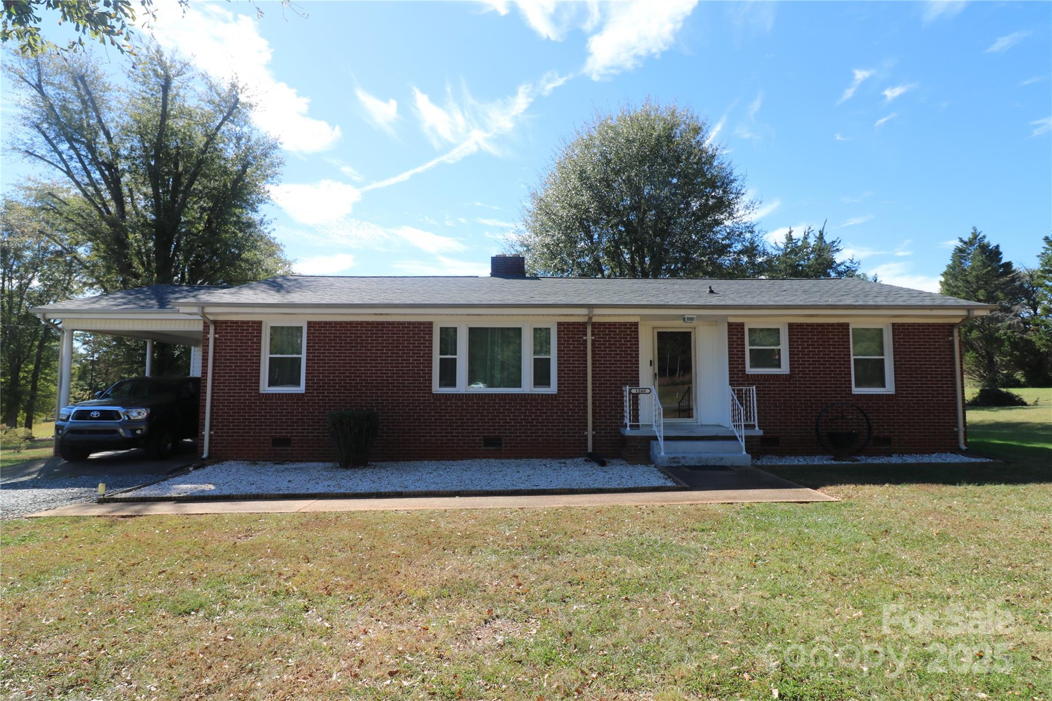 This is a well maintained 2 bedroom 1 and 1/2 bath brick home on 2 acres with a 2 car garage workshop.  The den could easily be a 3rd bedroom. It has a closet , window and doors that close on both sides.  A large living room open to the dining room has beautiful hardwood floors. New Ceilings throughout. New Ceramic tile flooring in both bathrooms. A large laundry room with a laundry sink.  Great location out in the country but close to business centers. The yard is very nice also.