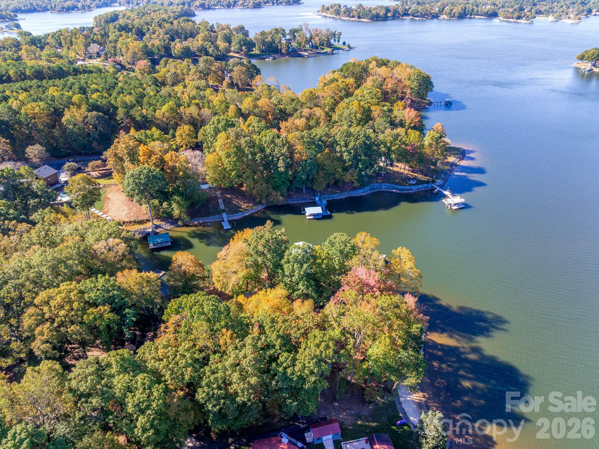 Set on a deep-water cove within the exclusive Fern Hill enclave, this rare multi-parcel offering spans nearly 8 private waterfront acres on Lake Norman—an extraordinary canvas defined by both scale and serenity. With approximately 120 feet of shoreline and an existing dock in place, the property is primed for immediate lake access while offering long-term potential for a truly exceptional estate.

Among the few remaining opportunities of its kind, this nearly 8-acre waterfront setting is distinguished by its mature trees, gently rolling topography, and sweeping water views illuminated by golden sunset exposure. Both private and expansive, it presents an unparalleled backdrop for a custom-designed residence or legacy compound on one of Lake Norman’s most coveted stretches.

Property is being marketed as land, offering flexibility for redevelopment or new construction. A to-be-built home concept is available under MLS #4351598, with additional opportunities under MLS #4346334. Existing residences may also be purchased separately under additional MLS listings, providing multiple pathways for acquisition and vision.

Located in Northern Mooresville with convenient access to shopping, dining, and approximately 40 minutes to Charlotte Douglas International Airport, the setting offers both privacy and accessibility.

Rare acreage, deep water, and exceptional privacy—an increasingly hard-to-find combination on Lake Norman.