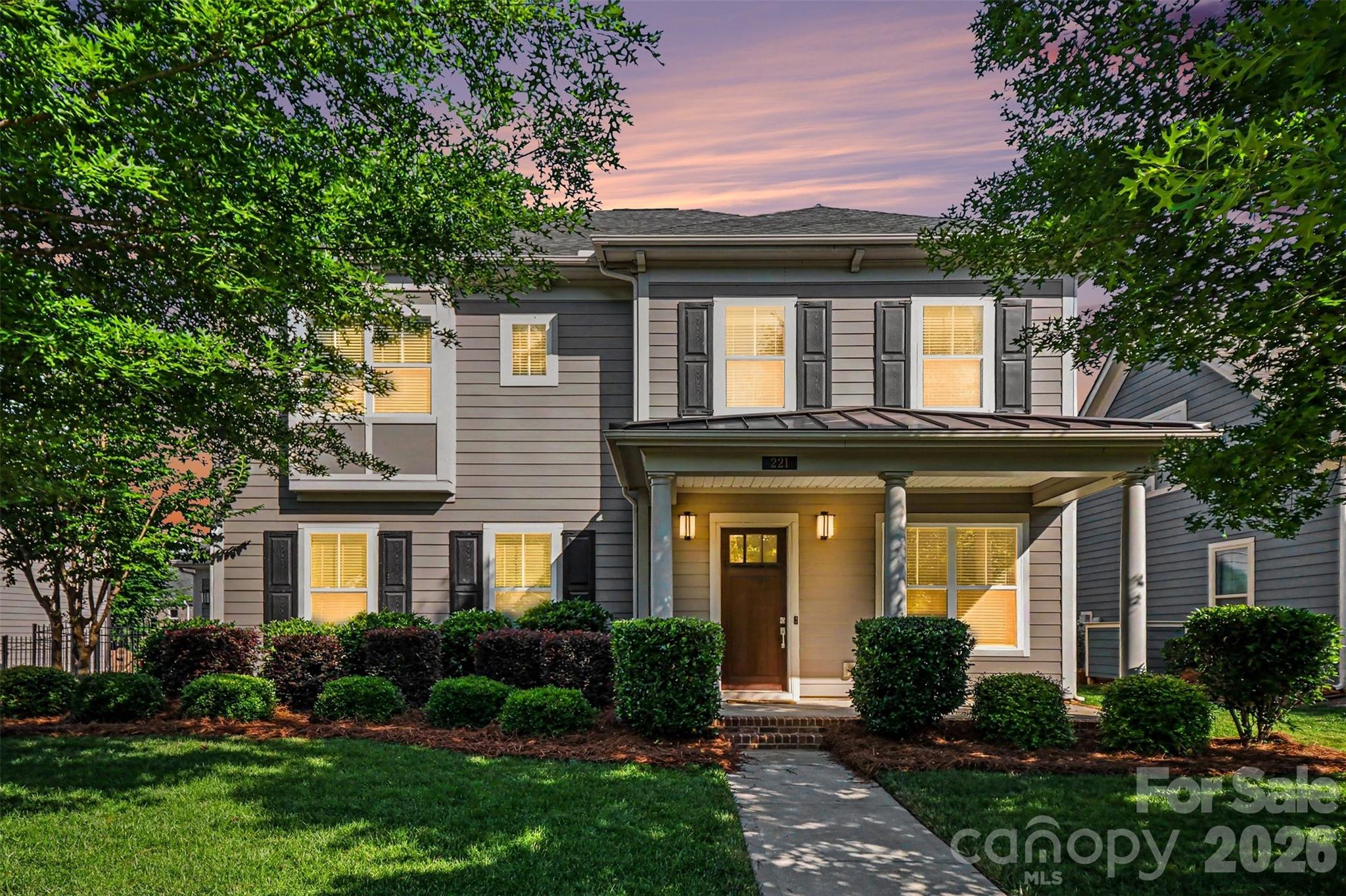 Welcome to 221 Hampton Trail Drive — a beautifully maintained home in the heart of Fort Mill offering nearly 3,000 square feet of thoughtfully designed living space, exceptional entertaining areas, and access to top-rated Fort Mill schools. Built in 2017 by John Wieland Homes, this 4-bedroom, 3.5-bath home combines modern comfort with upscale finishes throughout. From the moment you enter, you’ll appreciate the soaring 12-foot ceilings, open-concept design, and stunning floor-to-ceiling stone fireplace that anchors the spacious main living area. The chef-inspired kitchen is designed for gathering and entertaining, featuring a gas range, stacked cabinetry extending to the ceiling, abundant counter space, and seamless flow into the dining and living spaces. A dedicated office with paned glass doors creates the perfect work-from-home setup, while the main-level primary suite offers a private retreat complete with a luxurious oversized double shower. Upstairs, a versatile loft area is already equipped for movie nights with built-in surround sound ceiling speakers and projector wiring. Additional bedrooms include a convenient Jack-and-Jill bath layout ideal for family or guests. Step outside to enjoy a fully fenced backyard built for entertaining, highlighted by a custom stone paver patio, built-in seating wall, and fire pit — perfect for relaxing evenings or hosting friends and family. The whole-home and outdoor speaker system adds to the home’s impressive entertainment appeal. Additional upgrades include smart thermostats, a smart irrigation system, EV charger, and a rare 3-car garage with epoxy-finished flooring in the primary bay. Located in a highly desirable, walkable community featuring a neighborhood pool, playground, fire pit gathering area, sidewalks, and scenic pond trail with fishing access, this home also offers convenient access to I-77, shopping, dining, and everyday conveniences. A rare opportunity to own a beautifully upgraded home that truly balances comfort, functionality, and lifestyle in one of Fort Mill’s most sought-after areas.