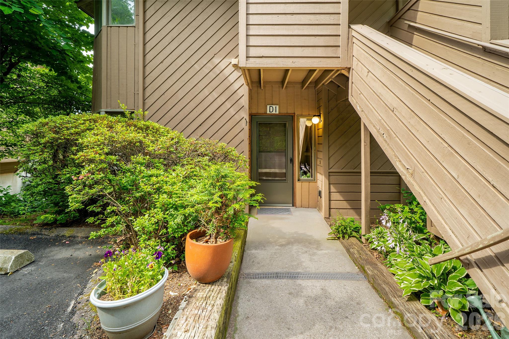 Tucked onto a west-facing mountain just minutes from downtown Asheville lies the city's best-kept secret: Pine Cliff Condominiums. This secluded oasis offers the dynamic energy of urban city life paired with the absolute tranquility of a wooded mountain retreat. Unit D-1 is a showcase of comfortable, single-level living featuring gorgeous winter mountain views and a charming cabin-like aesthetic set in the canopy of the woods. Step inside the ground level, steps away from parking, to an open-concept layout centered around a cozy gas fireplace with effortless remote control. Capturing mountain breezes is easy through upscale casement windows and screened doors. Zero deferred maintenance here—a premium mechanical overhaul in 2022-2023 replaced the HVAC, water heater, refrigerator, dishwasher, stove, washer, and dryer. This home has been carefully maintained. Complete with insulated double-pane windows, a community private outdoor pool, and wrapped in serene nature, this lock-and-leave mountain haven delivers total peace of mind. Exceptional Asheville living starts here. Schedule your tour before it’s gone.