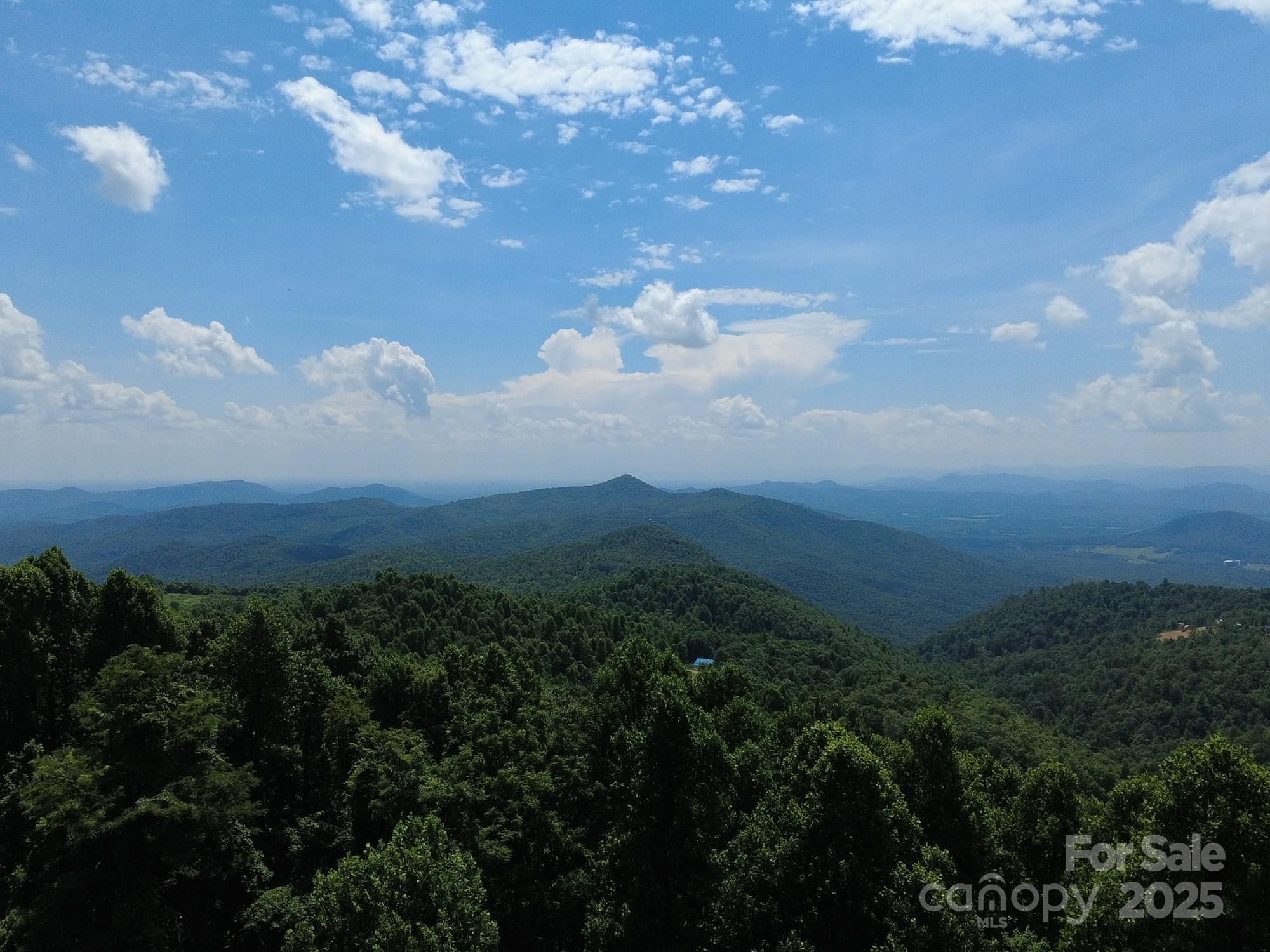 This remarkable and affordable South Mountain property offers breathtaking long-range views of the Appalachian Mountains on one side and Charlotte's distant skyline on the other. Experience true remote mountain living in a peaceful community where neighbors enjoy pristine nature, spectacular dual vistas, and thrilling 4x4 adventures right at their doorstep. Perfect for those seeking the ultimate escape from urban chaos, this rare opportunity provides complete privacy and serenity far from traffic and noise. Join fellow mountain enthusiasts who have discovered the magic of waking up to awe-inspiring views and endless outdoor exploration. If you're searching for that perfect place to truly get away from it all, your mountain sanctuary awaits where every day feels like a vacation.