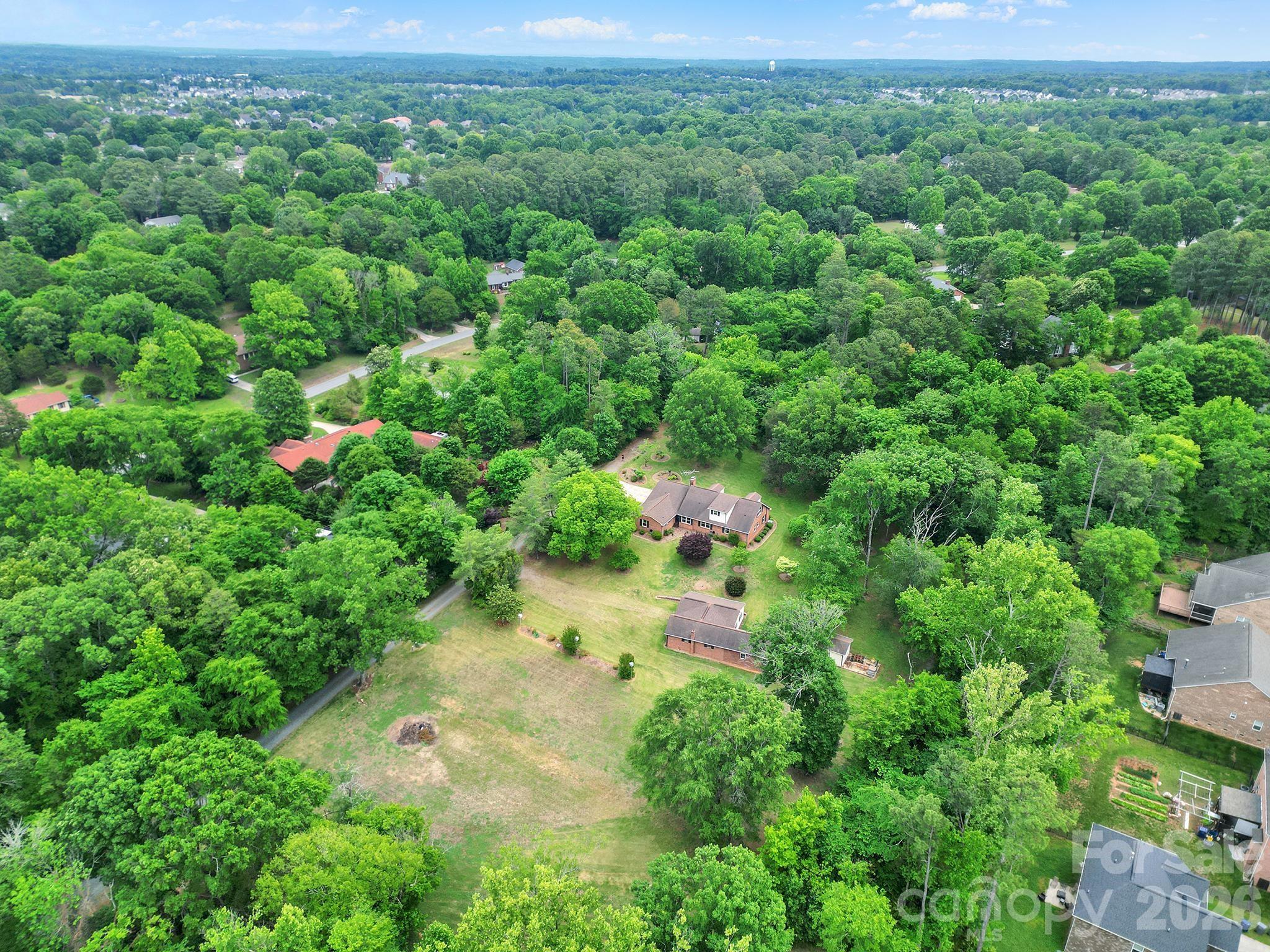 5.12 Acres in Growing NE Charlotte Corridor | Builder & Development Opportunity | Cabarrus County w/ Charlotte Address. Own 5.12 acres in the growing Caldwell / Tom Query corridor of Northeast Charlotte. Located in Cabarrus County with a Charlotte address. This Residential-zoned property offers incredible potential for an estate buyer, investor, or builder seeking future development opportunities. Most of the acreage has already been cleared, creating a strong head start for future use or development. Utilities available nearby. Existing 2,857 sq ft home with almost 1600 sq ft in outbuildings/workshop provides immediate use while exploring long-term possibilities. Ideal setting for a private estate, multi-generational living, or potential small-scale subdivision (subject to approvals). It is conveniently located near expanding residential growth, shopping, dining, and commuter routes while still offering privacy and space. A unique opportunity to secure acreage in one of the area’s evolving growth corridors. Property being sold “As Is.”