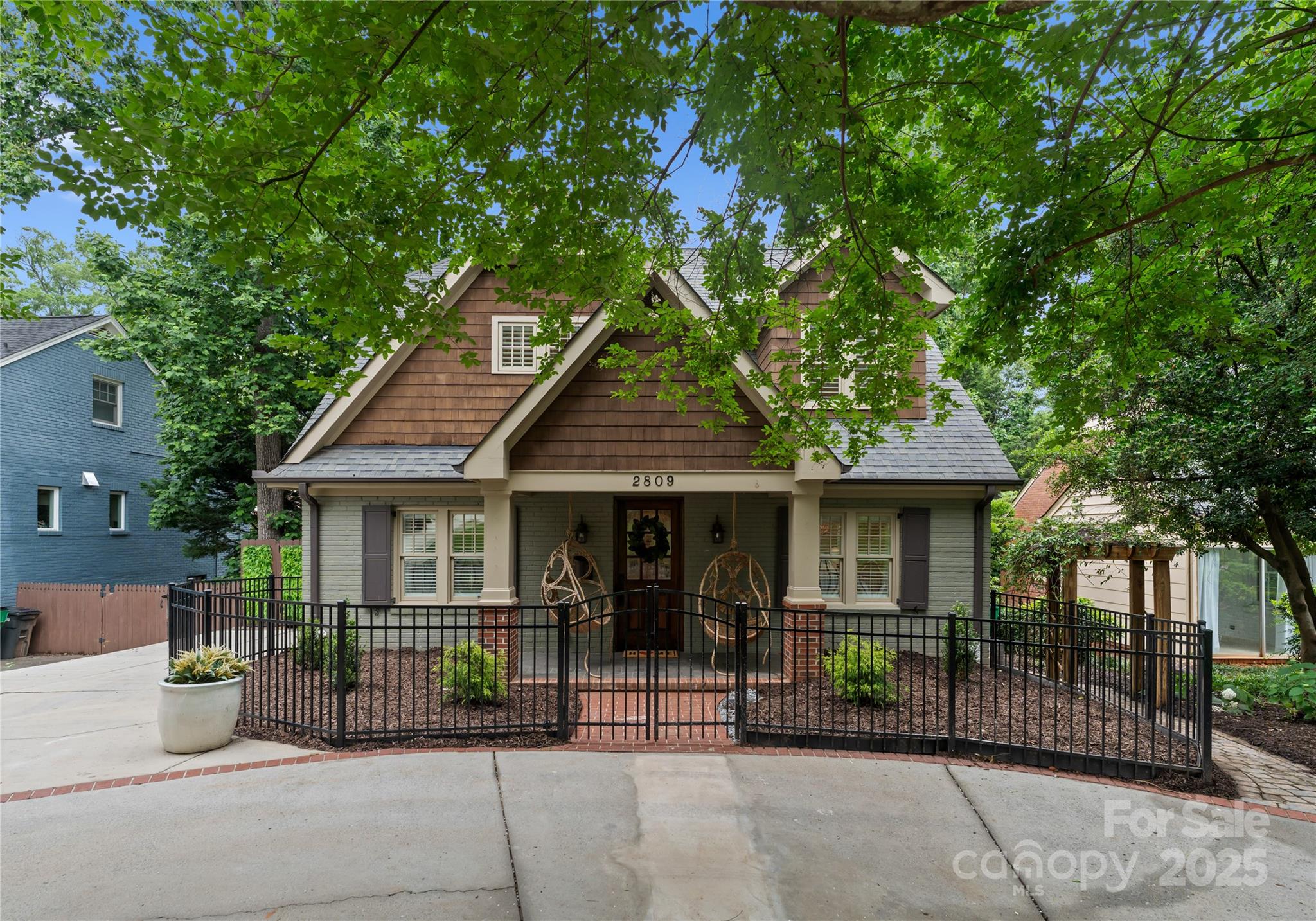 Welcome to 2809 Glendale Road—where historic charm, luxury renovation, and prestigious location come together in perfect harmony. This beautifully renovated 5-bed, 5-bath Arts & Crafts home offers over 4,400 sq ft of high-end living space on a quiet cul-de-sac. The open floor plan features a gourmet kitchen with premium appliances, flowing into a spacious great room—perfect for entertaining. The main-level primary suite provides a serene retreat, while the walk-out basement boasts a second living area, full kitchen, wine cellar, and private guest suite. Elegant finishes include hardwood floors, surround sound, and custom millwork. Enjoy the fully fenced backyard with a large patio and in-ground irrigation. Located within walking distance of Charlotte’s top dining, shops, and schools, this home offers refined living in one of the city’s most sought-after neighborhoods. A rare opportunity for luxury, location, and lifestyle in one exceptional property.