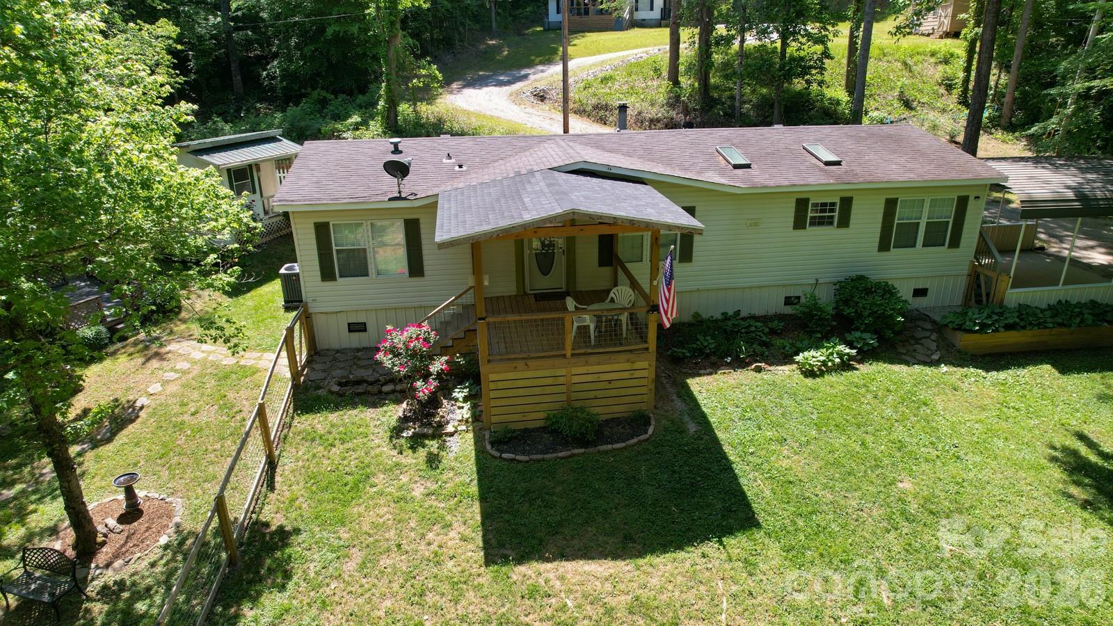 Discover this beautifully updated home situated on an acre of land, offering a rare blend of space, privacy, and functionality. Enjoy outdoor living at its best with a screened front porch and a new covered back porch overlooking a fenced backyard, mature trees, and a peaceful creek setting. The property also features a gazebo, garden shed, and an additional storage building, ideal for hobbies, workspace, or extra storage. Inside, the home showcases fresh interior paint, luxury vinyl plank flooring, and hardwood floors throughout. The living area includes a wood-burning fireplace, creating a warm and inviting atmosphere. The kitchen is designed for both everyday living and entertaining with ample counter space, a gas cooktop and oven, and a large pantry. All appliances convey with the home. Additional highlights include updated light fixtures, new blinds, spacious closets, and skylights that bring in natural light. The primary suite features a double vanity and a walk-in shower. A new HVAC system adds comfort and peace of mind.  Complete with a 12x10 garden shed and a 20x16 workshop with electricity and AC. This property offers a unique opportunity for those seeking space, outdoor features, and many update, all in one setting.