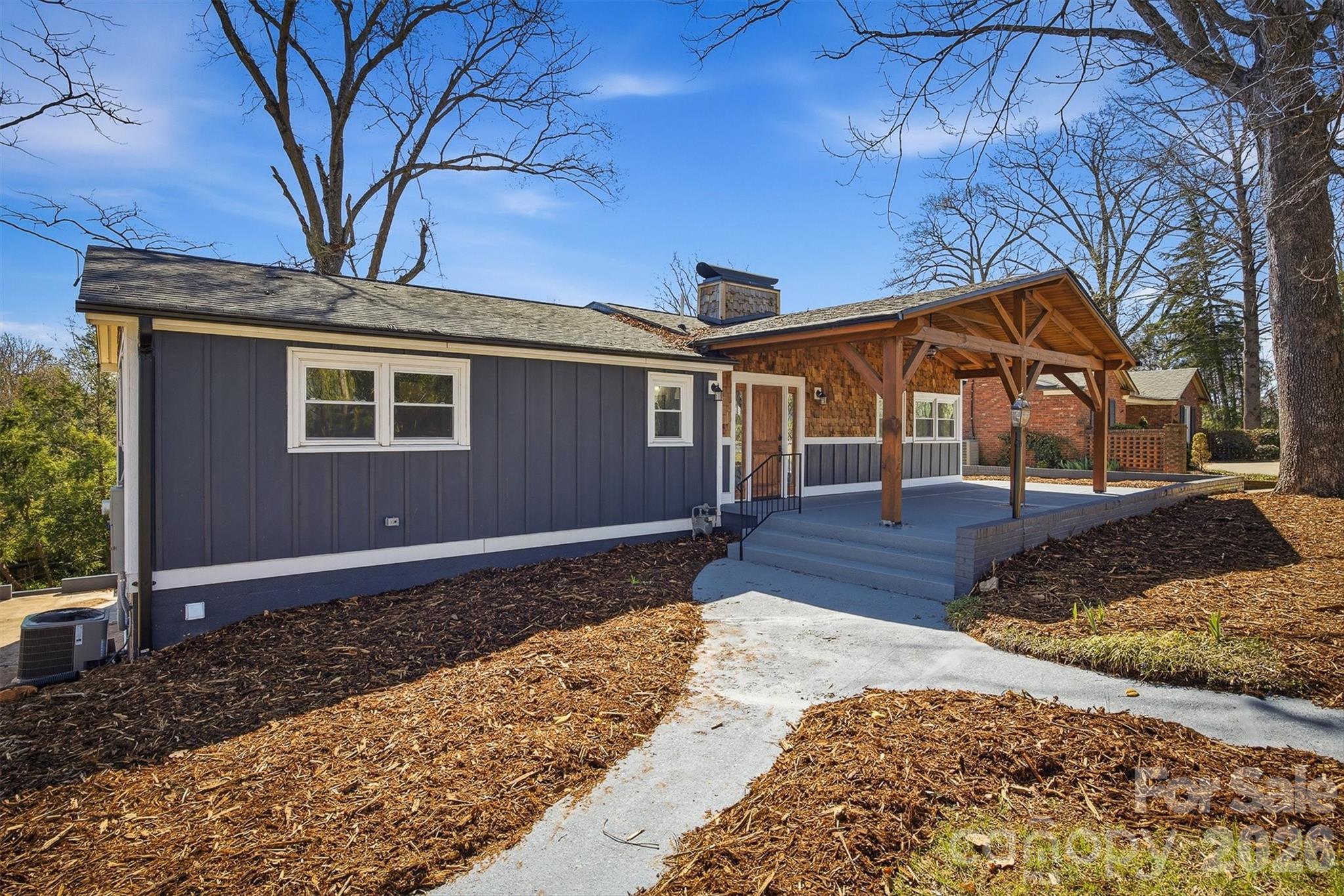Beautifully renovated home within walking distance of downtown Morganton.  Enjoy the charm and character of this 1959 built home with all the modern updates.  Open great room with exposed beam ceilings over the living, dining and kitchen areas. All new kitchen counters, cabinets and appliances.  Main level primary suite has spacious ensuite bath with double sinks, large walk in shower and two closets.  Additional 2 bedrooms and hall bath on the main floor as well as a large laundry room with sink and pocket office area.  Plenty of space to spread out with the finished lower level.  Open family room with 2 more bedrooms and full bath.  Convenient entry off driveway.  Brand new deck off main level dining area as well as supersized covered front porch and rear brick & concrete patio space for outdoor living. With all new electrical, plumbing, HVAC, roof, gas tankless water heater, Hardi and shake siding, theres nothing left to do but move in and enjoy your new home.
