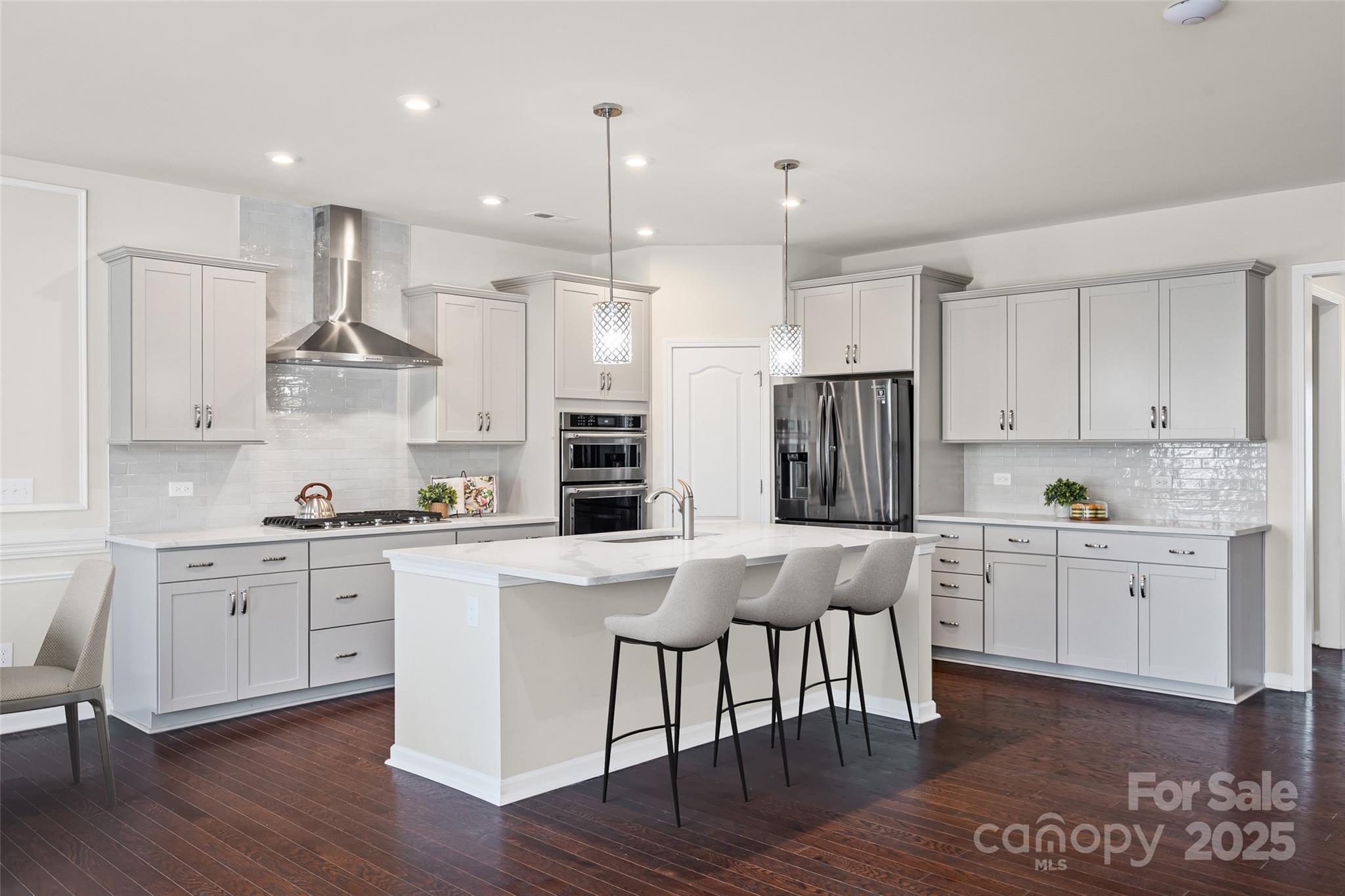 This showstopper chef's kitchen has brand new quartz counters and an expansive island, new tile backsplash, new stainless steel vented hood, gas range, and walk-in pantry - you won't want to miss this transformation! As you make your way in on stunning wood floors, the custom finishes throughout will impress you - shiplap, entryway built-ins, designer lighting, and more! The open & bright great room flows into the backyard, w/ an expanded paver patio w/ sitting wall & lights (over 400 sqft), and an elevated lot with long range views. Also downstairs is a bedroom & full bathroom with walk-in tiled shower, flex area, tons of storage closets, & garage w/ epoxy floors. Upstairs are another 3 bedrooms including a generous primary, 2 bathrooms, large loft, & laundry room. Too many upgrades to mention, incl landscape lighting, security system, fridge & W/D convey - see attachment for full list! McCullough is a lifestyle rich community w/ 2 pools, sport courts, dog park, near downtown Pineville, & 10 min from a light rail stop that takes you straight to uptown - welcome home!