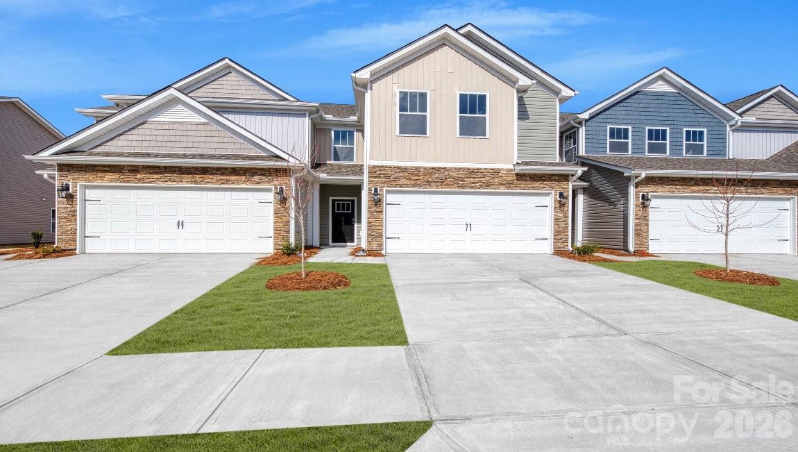 A new townhome community North of Asheville. These low maintenance townhomes offer 2 car garages and are close to everything Asheville has to offer! This floor plan features 4 bedrooms, 3 full bathrooms and at over 2200 square feet, there is room for everything you need. You will find one of the bedrooms on the main floor, next to full bath and just off the living room. Three additional bedrooms and two full bathrooms can be found upstairs, along with the laundry closet for added convenience! The open floor plan seamlessly blends the living room, dining room and kitchen areas for an open, bright feeling.
