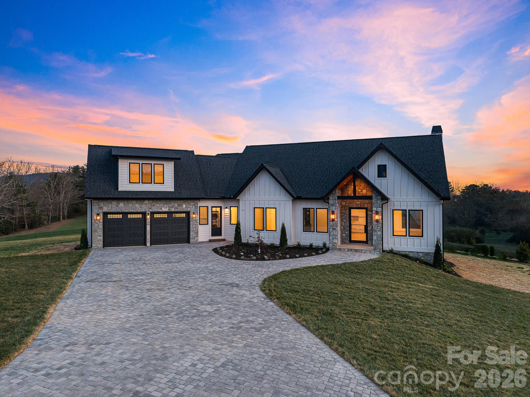 Brand-new, custom-built home offering luxury finishes and mountain views. This 3-bedroom, 3.5-bathroom property combines modern design with functional living.

The main living area features vaulted ceilings with exposed beams, massive windows framing the mountains like a piece of art, and a wood-burning fireplace with gas start and a black marble mantel.

The kitchen is equipped with professional Bosch appliances, Taj Mahal natural stone countertops with a full slab backsplash, custom cabinetry, and a spacious butler’s pantry.

Wide-plank white oak hardwood floors run throughout the home, along with Restoration Hardware lighting and a dedicated office/library with built-ins.

Each bedroom includes a private full bathroom and walk-in closet. The primary suite features heated marble floors and a custom walk-in closet. All bathrooms are finished with Italian marble tile and marble countertops.

Additional living space includes a large unfinished basement with windows, ideal for a gym, office, or storage, and an upstairs bonus room suitable for a media room or playroom.

Outdoor living includes a screened porch with a built-in grill, where you can enjoy the mountain views, along with a dedicated grilling area.

Additional features:
• Whole-home generator
• Commercial-grade Ubiquiti internet system
• Central vacuum system
• Custom iron front door
• Paver driveway
