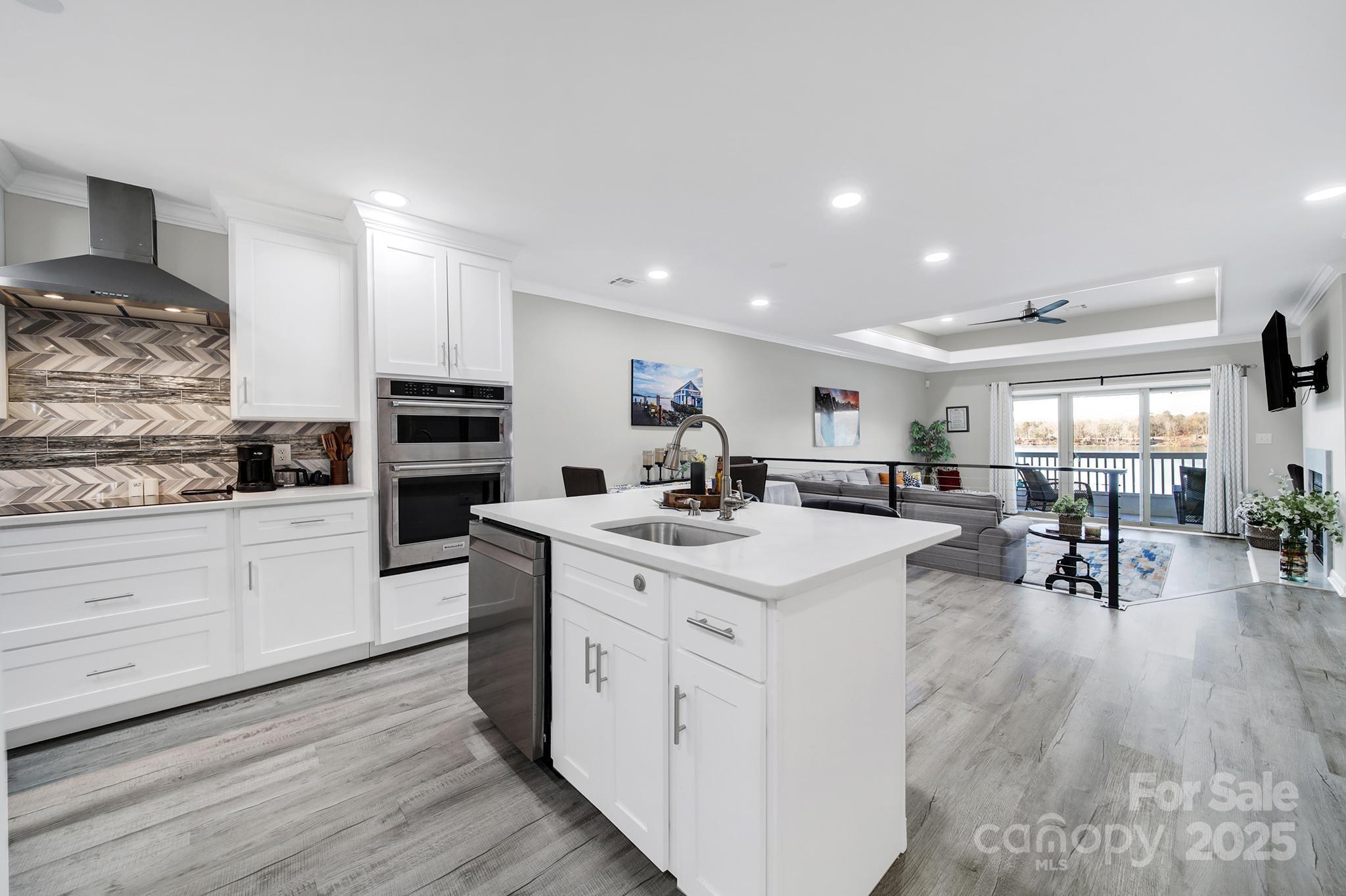 Priced below appraisal! Recently upgraded custom condominium located on the third floor on Lake Wylie, offering breathtaking water views from nearly every room. Located in a quiet yet vibrant community, the property offers easy access to outlet shopping, major highways, and Charlotte Douglas International Airport. The kitchen features a Bluetooth-enabled cooktop, custom island ideal for entertaining, detailed tile work, and stainless steel appliances. White marble flooring throughout creates a modern yet inviting atmosphere. A contemporary divider railing leads from the kitchen down to the living room and out to the balcony overlooking the lake. Additional highlights include a wood-burning fireplace, custom built-in desk, and custom primary closet. Both bathrooms feature LED mirrors. Unwind in the spa-like primary bathroom with a freestanding soaking tub and seated shower with three shower heads, including a rainfall feature. All appliances convey. Move in now and be ready to enjoy lake living this spring!   Schedule your showing today!