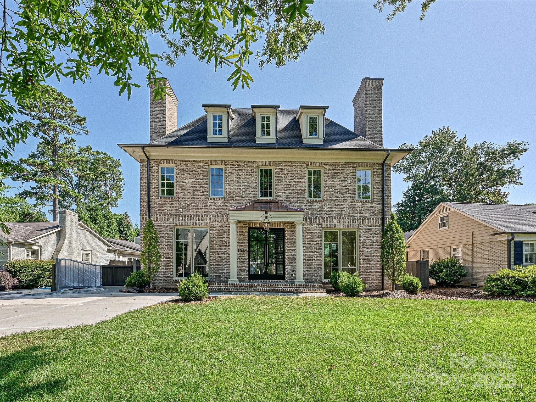Stunning new home built by Whittington Builders & designed by Aaron Cote is nestled in the heart of Myers Park on the upper end of tree-lined Maryland Ave. Spectacular Olde Carolina brick boasts a fabulous floor plan ideal for entertaining. The foyer welcomes you in & is flanked by a formal living & dining room each w/ fireplace. A wine room & scullery direct you to the gourmet kitchen which features Wolf and Sub-Zero appliances, custom cabinetry, island & breakfast room w/abundant light which opens to the great room w/ fireplace. Side entry brings the owners into a drop zone & separate office. Entertain all year long on the covered porch w/fireplace. On the 2nd level, you will find a private primary suite w/two walk-in closets & spa bathroom. 3 additional en-suite bedrooms & laundry room. 3rd level has 5th en-suite bedroom & bonus room. Carriage house has loft space w/ a full bathroom. Sought-after location close to shopping & restaurants.