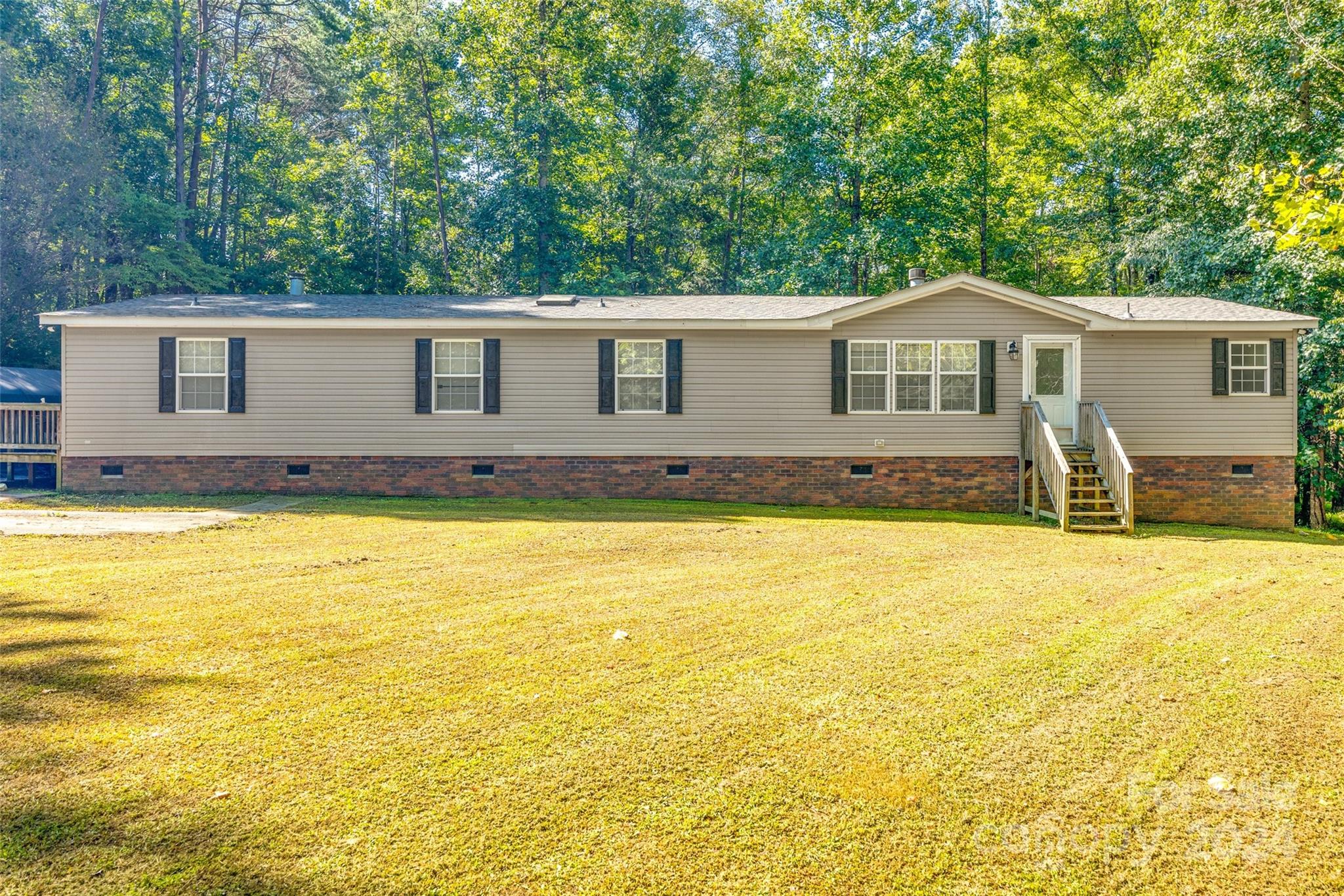 Discover this meticulously maintained 4-bedroom home in the sought-after Clover School District. Boasting 4 large bedrooms and 3 full bathrooms, this residence features a spacious layout with a living room, great room, and a versatile den with 2 sided fireplace, that could easily be used as an office. Enjoy cooking in the generously sized, recently updated kitchen and hosting meals in the separate formal dining room. Nestled at the end of a quiet dead-end street on over 2 acres surrounded by trees, this home offers exceptional privacy. Conveniently located near Lake Wylie, Rock Hill, York, Gastonia, Charlotte, and more, it combines tranquility with accessibility.