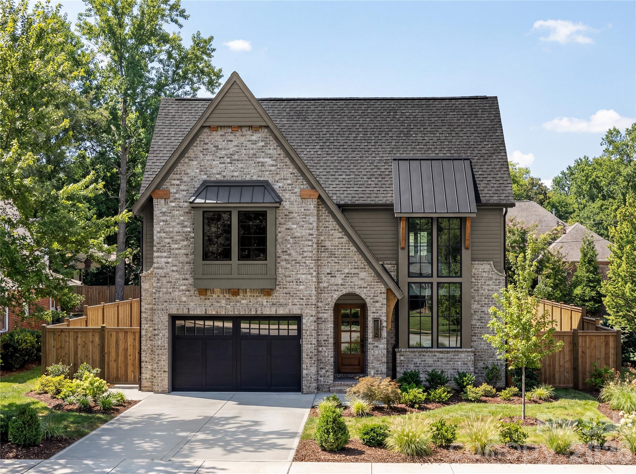 Welcome to 1646 Arnold Drive, a thoughtfully designed new construction home that blends timeless architecture with elevated, designer finishes just minutes from Uptown Charlotte.

From the moment you arrive, the home makes a statement with its beautiful brick exterior paired with fiber cement siding that gives the home classic curb appeal.

Inside, you’ll find 5 bedrooms and 4 full baths, including a main-level primary suite and four additional bedrooms upstairs. The open-concept main level is filled with natural light and features 10-foot ceilings, a spacious family room with a stunning fireplace, and a seamless flow into the dining area and kitchen.

The kitchen is truly the heart of the home, complete with custom cabinetry, a large island, and carefully selected finishes. Just behind it, a fully equipped scullery offers additional cabinetry, prep space, and a wine fridge, creating both beauty and function for everyday living and entertaining.

The primary suite is a peaceful retreat with vaulted ceilings, a spacious walk-in closet, and a spa-like bath featuring a soaking tub and walk-in shower.

Step outside to a covered rear porch with a built-in fireplace, overlooking a large backyard that's perfect for hosting or relaxing year round.

Additional features include a 2-car garage and a location that puts you less than 10 minutes from Uptown Charlotte, offering both convenience and lifestyle.

A rare opportunity to own a beautifully finished, design-forward home in one of Charlotte’s most desirable areas.