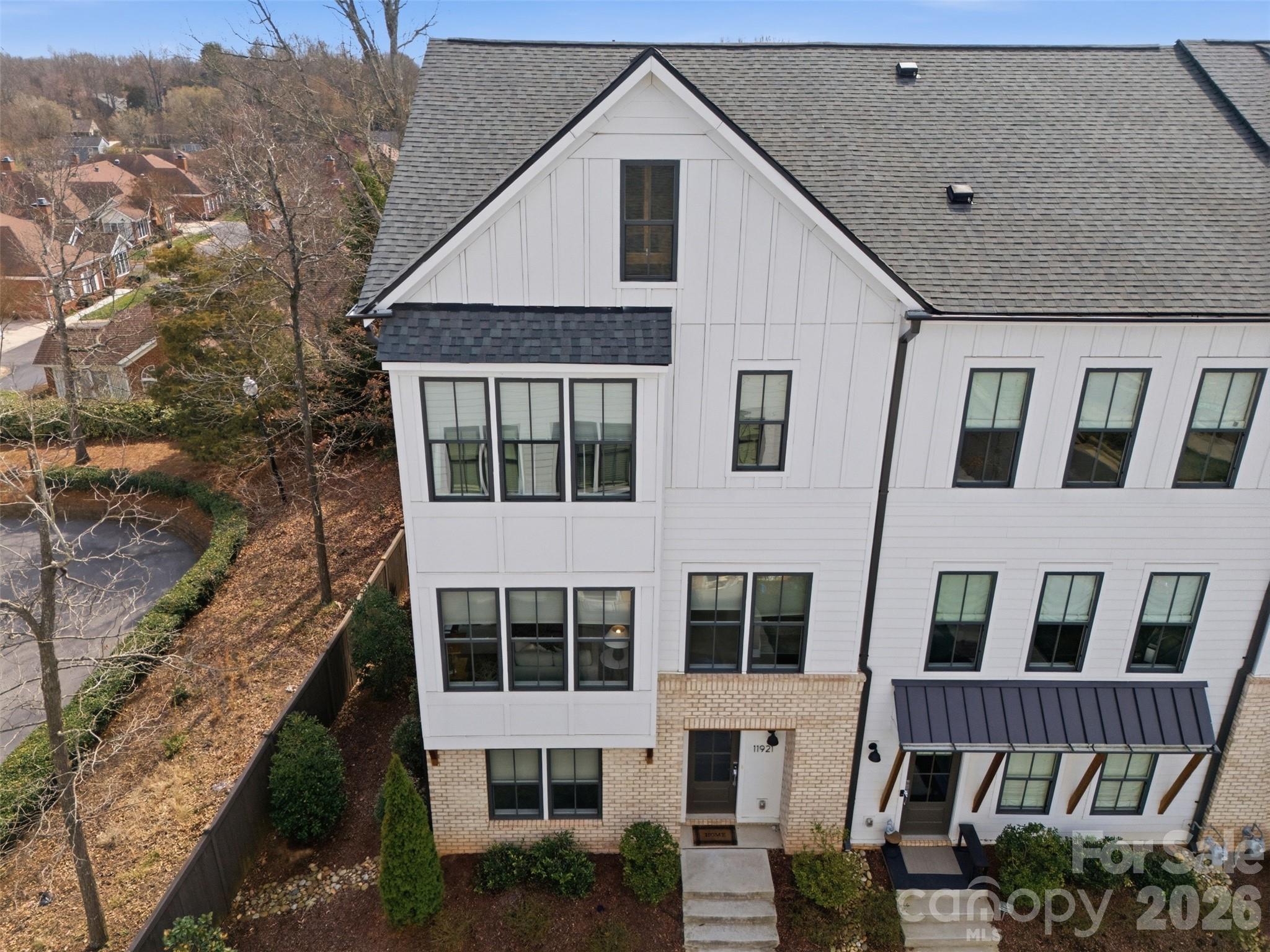 LENDER INCENTIVES and SELLER PAID CREDIT FOR 2026 HOA DUES! Exceptional Value at this END UNIT 2021 built townhome! Inside, over 2700 square feet is filled with elevated details including upgraded lighting, designer fans and vanity, custom built-ins and millwork, hardwood floors, gas appliances, walk-in pantry, 2 car garage, ROOFTOP TERRACE! Appreciate a home with natural light? Look no further. This thoughtful design offers expansive windows that flood the open floorplan with natural light. The home features 3 bedrooms, 3 full and two half bathrooms, plus a spacious bonus room. ENTRY LEVEL BEDROOM and full bath offer flexible options as space for home office, exercise or guest suite. Elm Terraces is a boutique community of just 20 townhomes with walkable access to the local farmers market, shopping, dining, fitness, while coming home to a quiet residential setting. Located near Ballantyne, Stonecrest and Blakeney, this home offers a standout opportunity in one of South Charlotte’s most connected locations! Lawn Maintenance/Landscaping Included. Refrigerator, washer and dryer to convey!