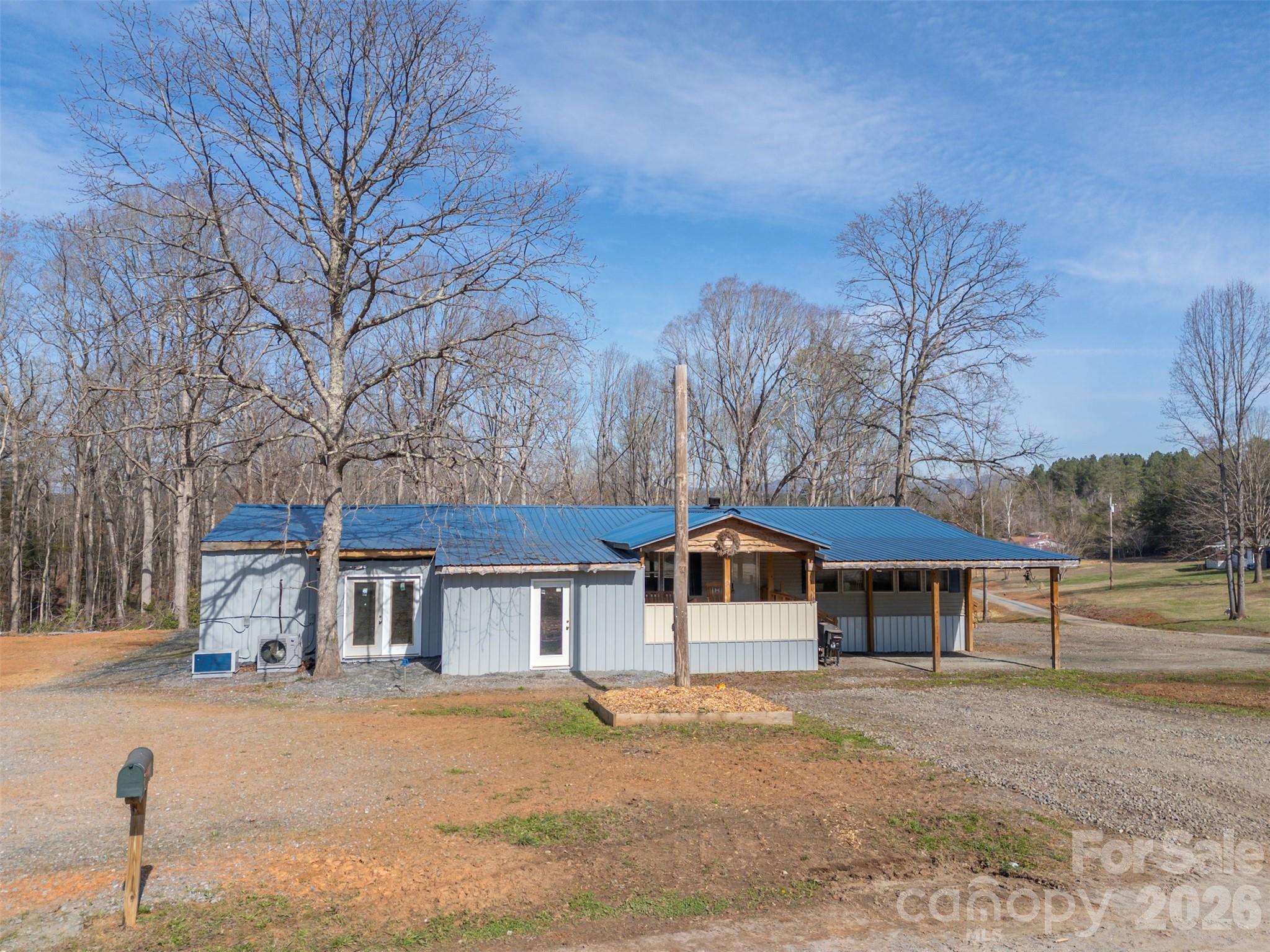 Tons of potential with this parcel just under 2 acres in tranquil rural setting of Lawndale.  Property features a 3 bedroom 2 bath manufactured home w/wood-burning fireplace, spacious eat-in kitchen w/island, mudroom/laundry and huge covered front porch.  Several large rooms have been added onto the home, including a walk-in cold storage.  Areas are fully insulated, wired & climate-controlled with mini-splits and just need the finishing touches.  Stocked spring-fed pond w/covered pier for hours of fishing enjoyment or just observing the wildlife.  Several areas of cleared pasture and clear-cut trail down to the back of the lot.