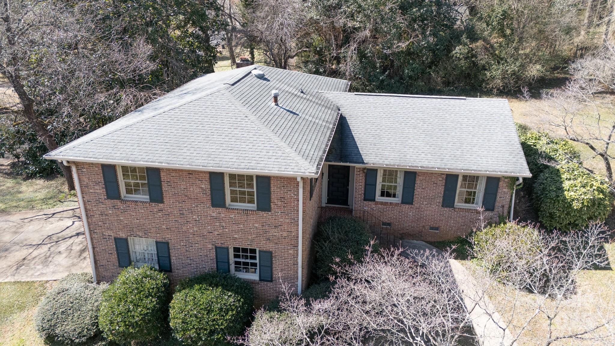 ONE OWNER! QUALITY CONSTRUCTION! ALL BRICK! This lovingly cared for home exudes quality, character and charm!  The sunny kitchen overlooks the back patio and treescape for ease of outdoor entertainment as well as beauty and natural scenery.  The main level flow is great for entertaining and offers, real wood floors and lots of windows. a few steps up..... 4 spacious bedrooms all with large closets and REAL HARDWOOD FLOORS under the carpet (one room has the carpet removed so you can see the condition and beauty!)  Several linen closets,a large primary bedroom ensuite, with walk in closet and attic nook all upstairs.  There is a cozy den in the lower level with real wood fireplace, built ins and driveway entrance. An oversized laundry room and attached double car garage w/ tons of storage also on the lower level - easy drop zone.  All situated on a corner lot with tons of outdoor enjoyment potential and located just minutes from schools, interstate, shopping and dining!