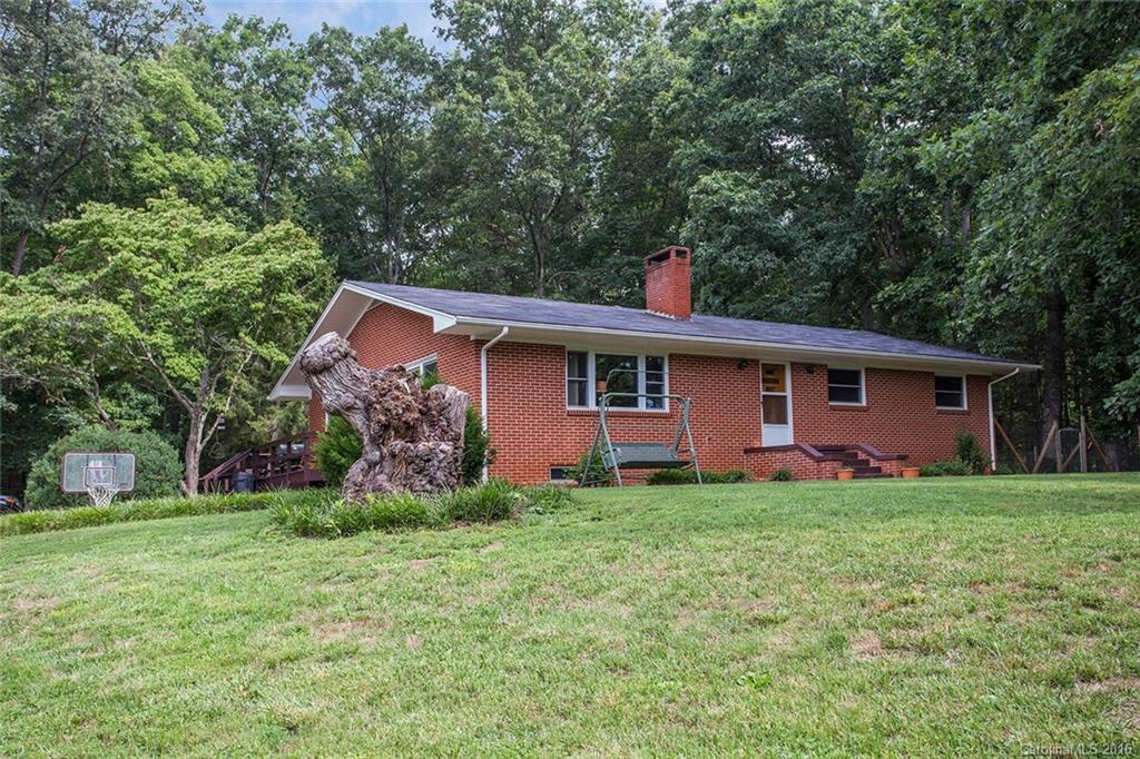MULTIPLE OFFERS RECEIVED! HIGHEST & BEST OFFERS DUE BY MONDAY, 8/1, AT 5 PM! Enjoy private, rural bliss without the long drive from town! 14.26 beautiful acres with your own creek. Zoned as Open Use so the possibilities are endless. Classic brick ranch style home with full basement. Huge detached 3-car garage that can also be used for storage or a workshop. Majority of the land is already completely fenced for horses. Minutes to town, shopping, and restaurants. Perfect for an investor as well.