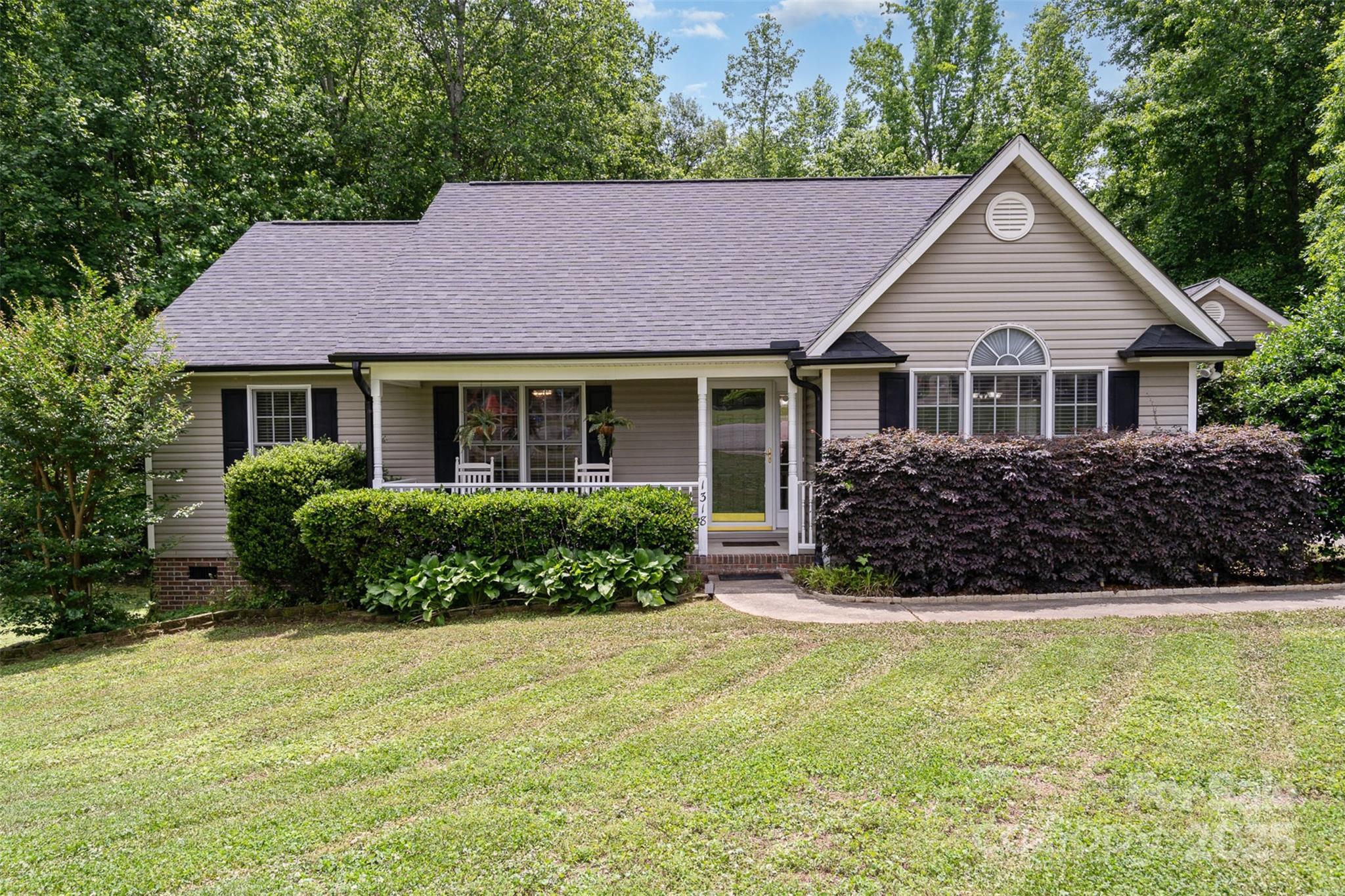 Beautifully updated home on over an acre in a quiet cul-de-sac, with a peaceful creek running through the back of the property. The updated kitchen features granite countertops and white cabinetry for a clean, modern look. Enjoy the outdoors from the screened-in back porch, and make use of the large detached garage, built-in carport, and workshop for all your storage or project needs. Recent improvements include a newer roof, water heater, and gutters with leaf guards and new downspouts. This well-maintained property offers space, privacy, and convenience close to everything Gastonia has to offer!