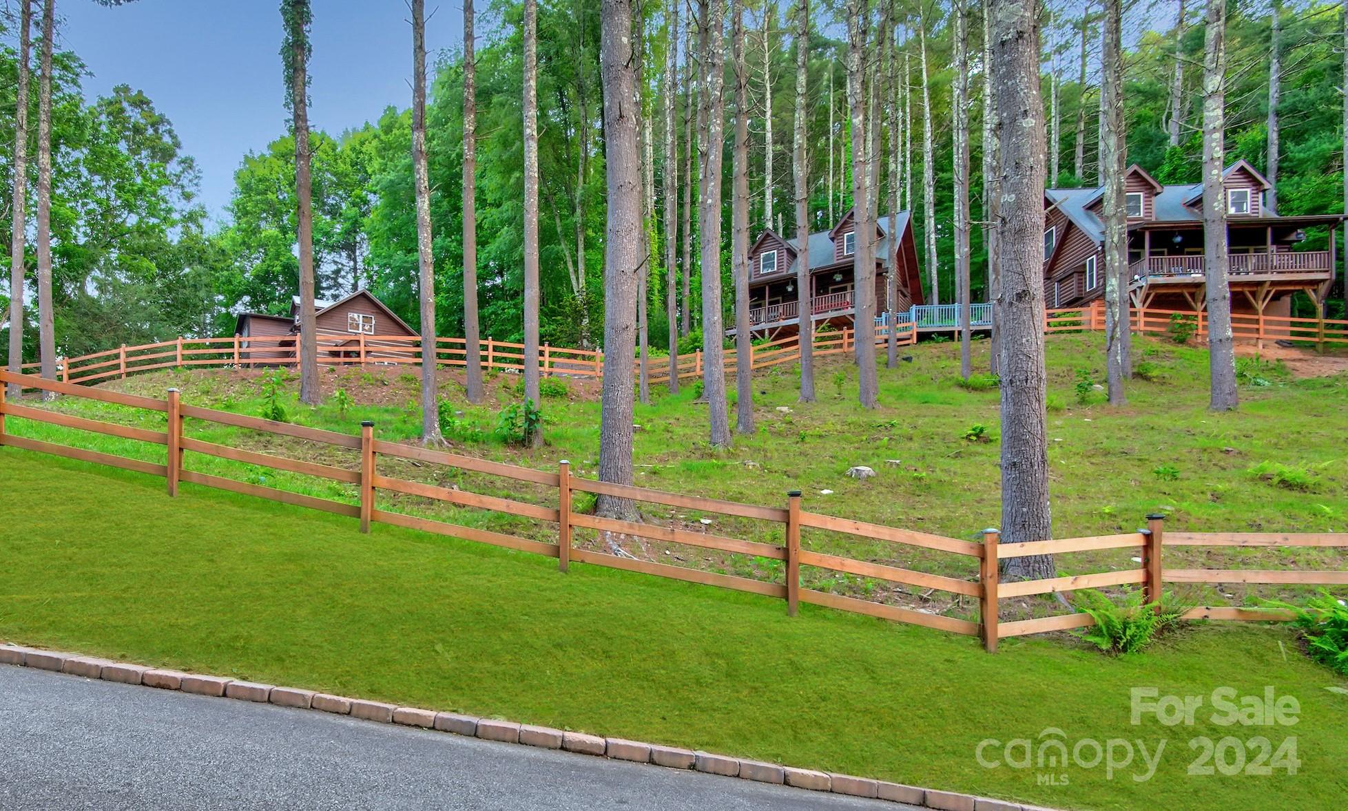 Don't miss this captivating 5-cabin property on 9 acres, including 6 undeveloped acres on the ridge, centrally located between Boone and Banner Elk. The property saw strong rental income in 2022 & 2023—and its new, boutique rental management program offers passive ownership with a high-ROI venture from day one and room to grow! One studio cabin, one 1BD/1BA cabin, two 2BD/1BA cabins, and a deluxe 2BD/2BA cabin—all within a 1/2 mile to the iconic Mast General Store & Valle Crucis Park. Lighted pathways will guide your guests to the neighboring inn for delightful evenings of fine dining and live music. Flexible and spacious for family reunions, corporate retreats, event stays, or individual vacation rentals. Current 6 BR septic and well permits for the undeveloped ridge. Utilize the roughed-in drive and available build sites for your dream residence or explore further revenue growth with additional cabin builds, amenities, or event space. Come see this fantastic property today!