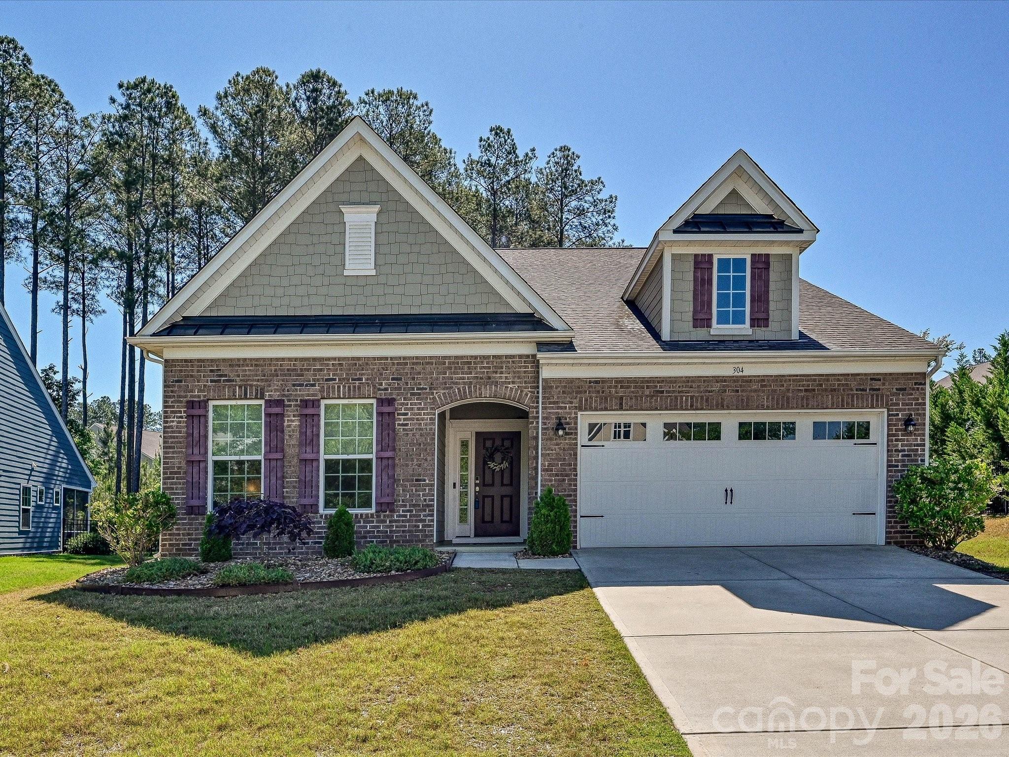 Welcome to your 4BR/3BA 1.5-story home in amenity-rich Imagery, a 55+ community where nature abounds on a peninsula of Mountain Island Lake! This 2,762 sf home offers a large Owner's Suite on the main level with a sitting area and a covered porch and 2 additional bedrooms. Enjoy an open floor plan with an extended Great Room, LVP floors, a Gourmet Kitchen with a gas cooktop, granite counters, stainless steel appliances, a huge island, and a walk-in pantry. Upstairs, you'll find a bedroom, a full bath, and a roomy family room with lots of storage. Walk out back and enjoy your brick paver patio and fire pit, or enjoy Imagery's pool, pickleball, tennis, beach, trails, waterside parks, arts studio, sewing cabin, fitness center, library, game room, and dog park. Lawn maintenance and an on-site Lifestyle Director are also included! A WATERFRONT PARK with BOAT DOCKS, JET SKI SLIPS, and KAYAK ACCESS IS UNDER CONSTRUCTION!  10 mins to local shopping and I-485, 20 mins to the Airport, Uptown, major shopping, restaurants, medical facilities, and Lake Norman. Under-55 buyers are welcome!