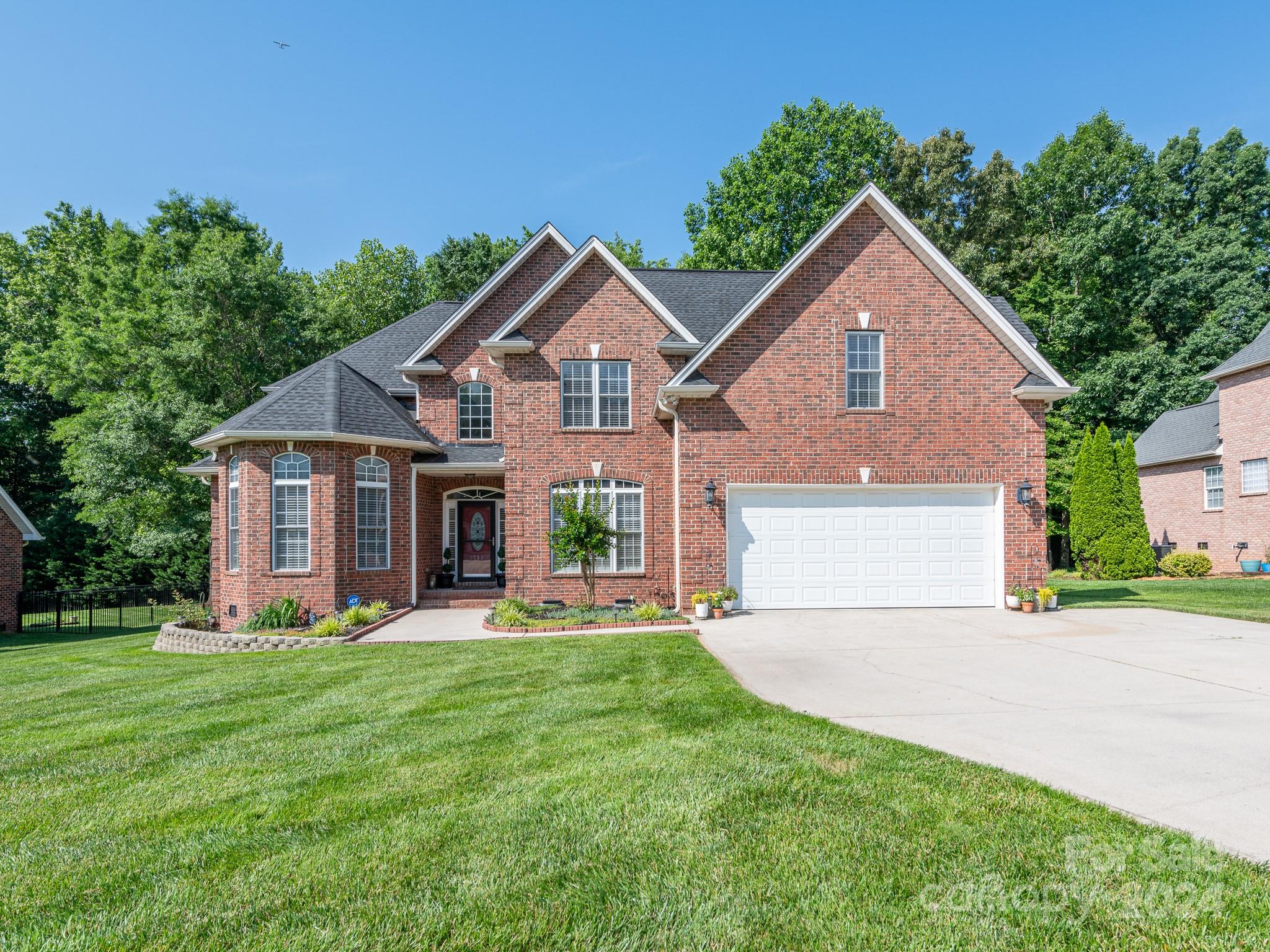 2 BEDROOMS DOWNSTAIRS & 3 BEDROOMS UPSTAIRS....BONUS ROOM...SCREEN PORCH...STORAGE.....Welcome to this beautifully appointed brick home, offering a perfect blend of elegance and comfort. 5 BEDROOMS 4 FULL BATHROOMS spacious bonus room on the second floor, this home provides sufficient space for generational living.  The custom curved balcony adds a touch of sophistication, overlooking the inviting living room. The large kitchen is ideal for entertaining and everyday living, making this home a true delight. Step outside to a backyard reminiscent of a secret garden, best enjoyed from the SCREENED PORCH or the al fresco dining patio. Nestled in a beautiful, established neighborhood, this home is a rare find. Schedule your viewing today and discover the charm for yourself!