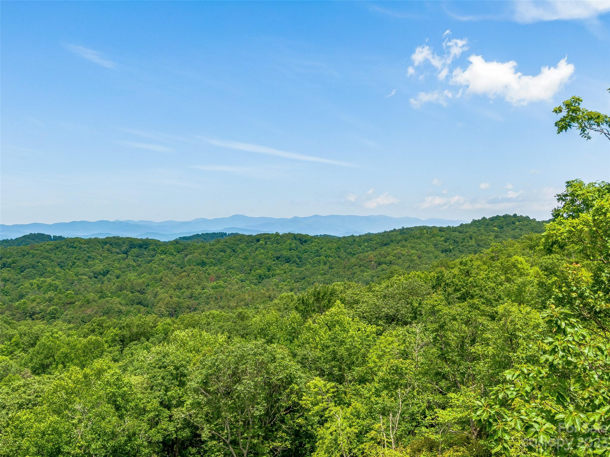 Discover a hidden gem nestled within the Big Hill community in Brevard, NC—a magnificent 3.54-acre wooded lot that promises an enchanting retreat. Immerse yourself in the breathtaking beauty of nature as you gaze upon the awe-inspiring 180-degree western views, capturing the splendor of the setting sun. The landscape unfolds before your eyes, revealing a tapestry of layered mountain views, each peak more majestic than the last. A gentle sloping building site invites your creativity and beckons you to design your dream home within this natural oasis. Embrace the tranquility of the surrounding woodlands, where mature trees provide shade and seclusion, ensuring a sense of privacy. This idyllic sanctuary offers an unparalleled opportunity to live amidst nature's wonders while indulging in the comforts of a serene mountain lifestyle.