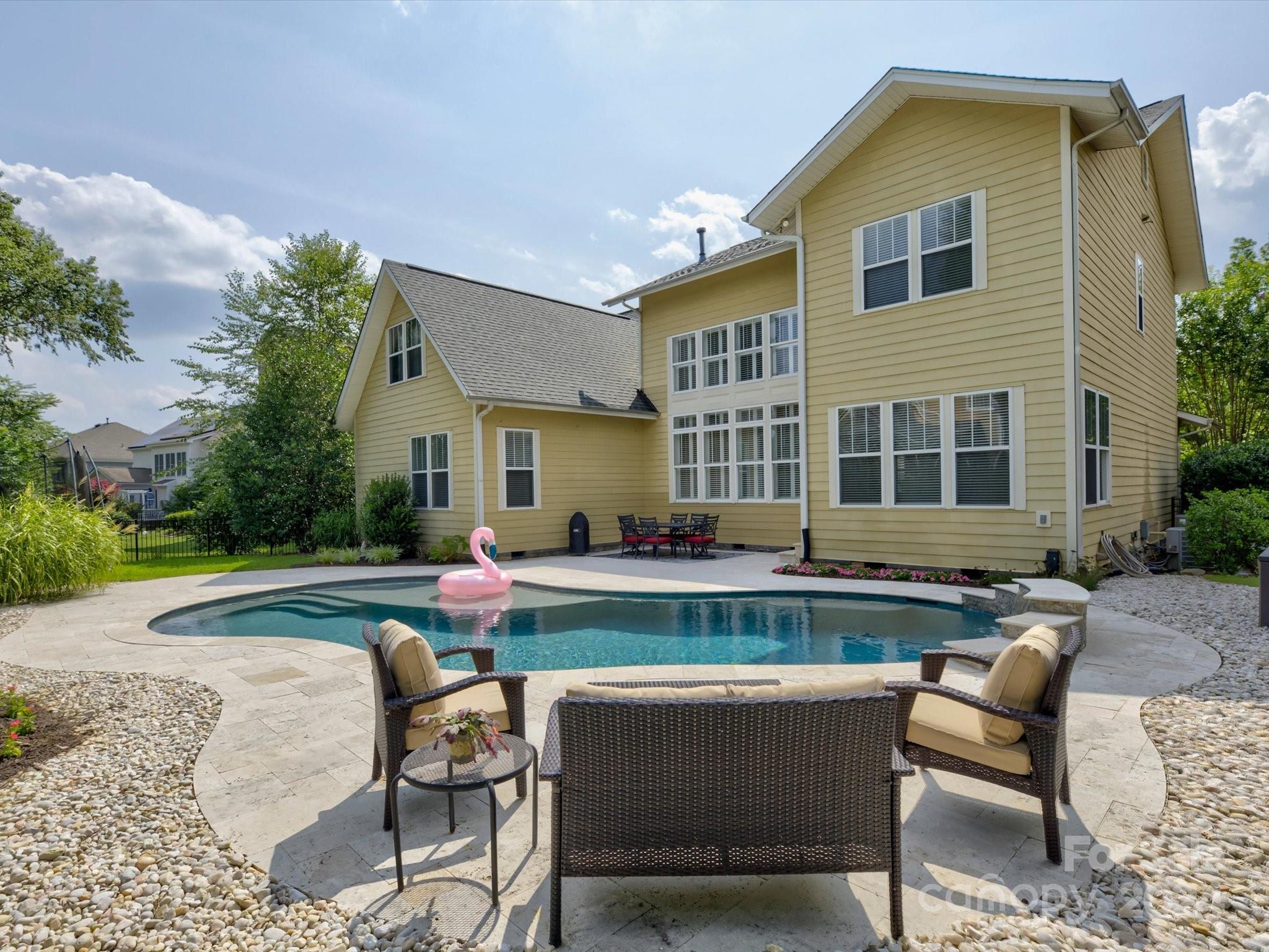 Welcome to your new home sweet home! This gorgeous 4 BR gem has everything you've been looking for and more. Imagine relaxing in your own heated, saltwater gunite pool, surrounded by beautiful travertine tile. The fenced-in backyard is perfect for gatherings, gardening, or just letting the kids and pets run free. Inside, you'll find  plantation shutters that add a touch of elegance. The main level features a spacious primary bedroom, making life a little easier. There's plenty of walk-in storage through the bonus room. Whether you need a space to work from home or a quiet spot for hobbies, the cozy office has you covered. Plus, the bonus room is a flexible space you can use as a playroom, home gym, or whatever you need.  NEW CARPET! This home is all about comfort and convenience, with thoughtful touches everywhere you look. Come see it for yourself and get ready to fall in love! Enjoy all that Tega Cay has to offer; pool, tennis, lake access, golf, walking trails and so much more!