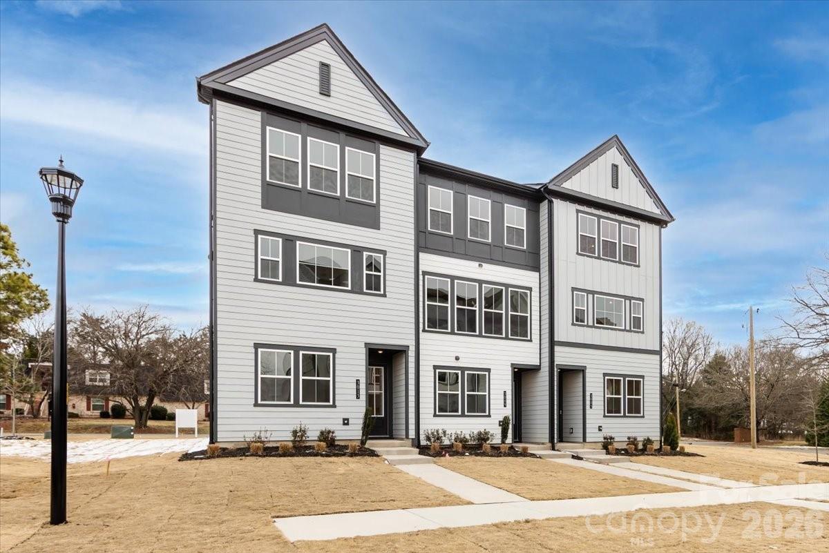 This end-unit townhome offers 3 bedrooms, 2.5 baths, and 2,080 square feet of timeless design filled with natural light. Premium finishes throughout create a look that feels both refined and enduring. The gourmet kitchen features warm-toned stained wood cabinetry and a large central island, while 8-foot sliding glass doors open to a covered outdoor living space. An oversized two-bay tandem rear-load garage adds everyday convenience. With no direct rear neighbors and close proximity to the community dog park, the home offers privacy and connection in equal measure. Located in Bellflower with quick access to Rea, Pineville-Matthews, and Providence Roads, this home keeps you close to everything that matters.