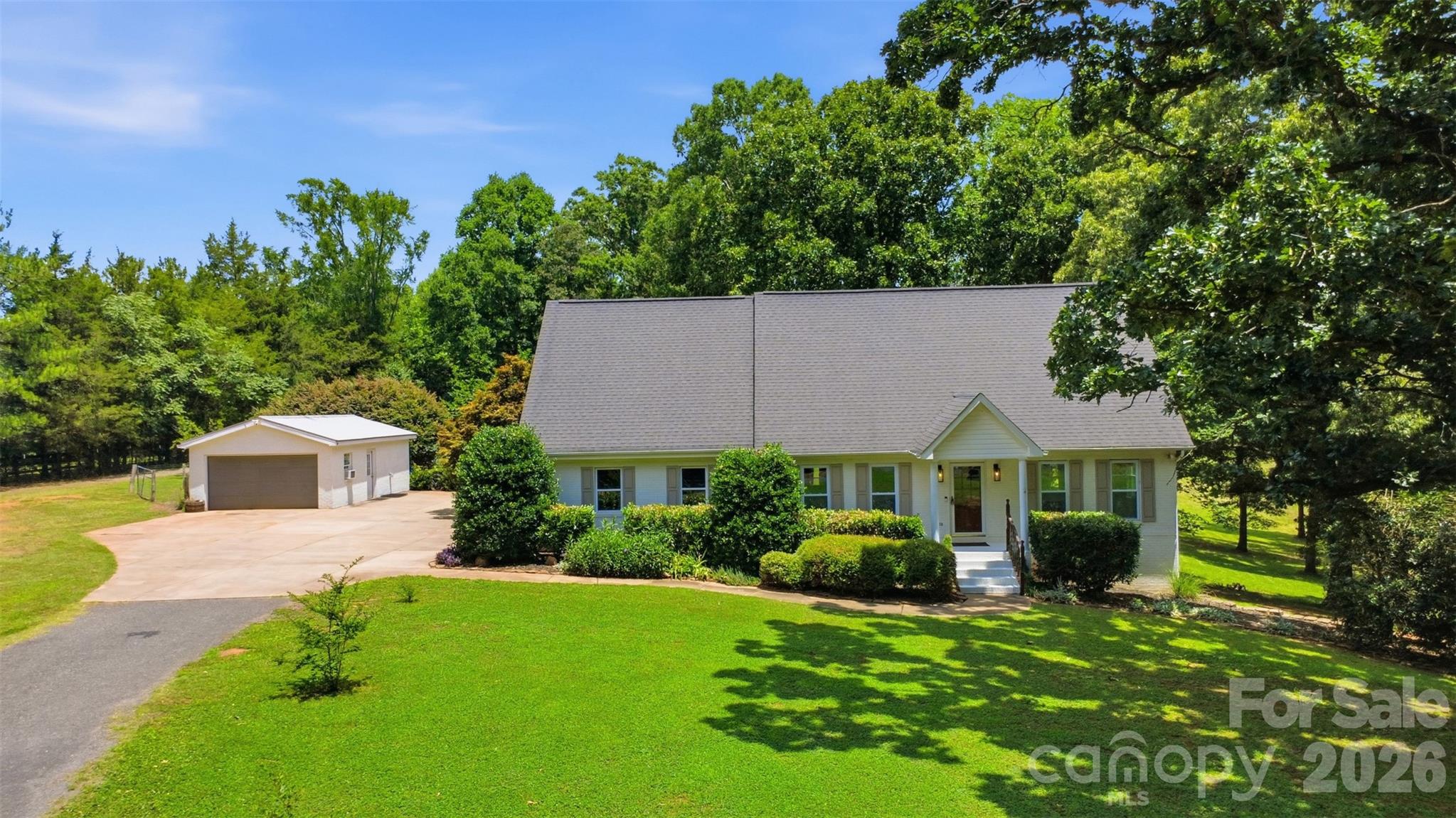 Calling all those seeking serenity without sacrificing convenience! This exceptional property offers the perfect blend of rustic charm and modern amenities, all within easy reach of town and major routes. Imagine waking up to the tranquil beauty of your own expansive grounds. Situated on almost 10 acres of beautiful, mostly cleared land that is entirely fenced in—perfect for animals, recreation, or simply enjoying the peaceful views and sounds of nature. The backyard is an entertainer's and hobbyist's dream, featuring a cozy fire pit for evening gatherings, a functional barn ready for your equestrian dreams or storage needs, and an thriving garden area with blueberry bushes, peaches, plumbs, herbs, grapes, blackberries, and your very own mulberry tree. In addition to the attached garage, the property boasts a detached 2-car garage ideal for extra vehicles, equipment, workshop, or for all your toys. 

Venture inside to a highly functional layout with brand new windows and flooring throughout. A full bathroom and dedicated laundry room right on the main floor. Relax and take in the views on the covered screened in back deck complete with a bubbling Jacuzzi, your own private oasis for relaxation and entertaining. The welcoming living area showcases custom built-ins and a striking fireplace, while the unique fully renovated kitchen offers a large center island, a charming stacked-stone backsplash, and ample cabinetry. For all you chefs the kitchens main feature is a 39" free standing gas AGA range with 2 hotplates, 4.5 cu ft capacity, double oven, boiling plate, and simmering plate. There is no food, this range cannot prepare to perfection! The main level also boasts a formal dining area, or designated den, connecting to your very own corner office through a set of french doors.  

Head upstairs to find a sprawling finished space. This level comfortably hosts 2 spacious bedrooms, an ample bonus/3rd bedroom, and 2 full bath to accommodate family or guests. The basement serves as a private primary bedroom suite, complete with its own walk-in closet and designer bathroom. Step outside through french doors of the primary suite to the side yard to see a beautifully stacked block retaining wall and rock lined flower bed.

Don't miss the opportunity to own this versatile and beautifully situated estate with a Location that Can't Be Beat: Enjoy the peace and quiet of country living while being close to the amenities of Waxhaw. Convenient access to Route 521 simplifies commuting and a comfortable 30-minute drive puts you in the heart of Ballantyne with everything it has to offer.