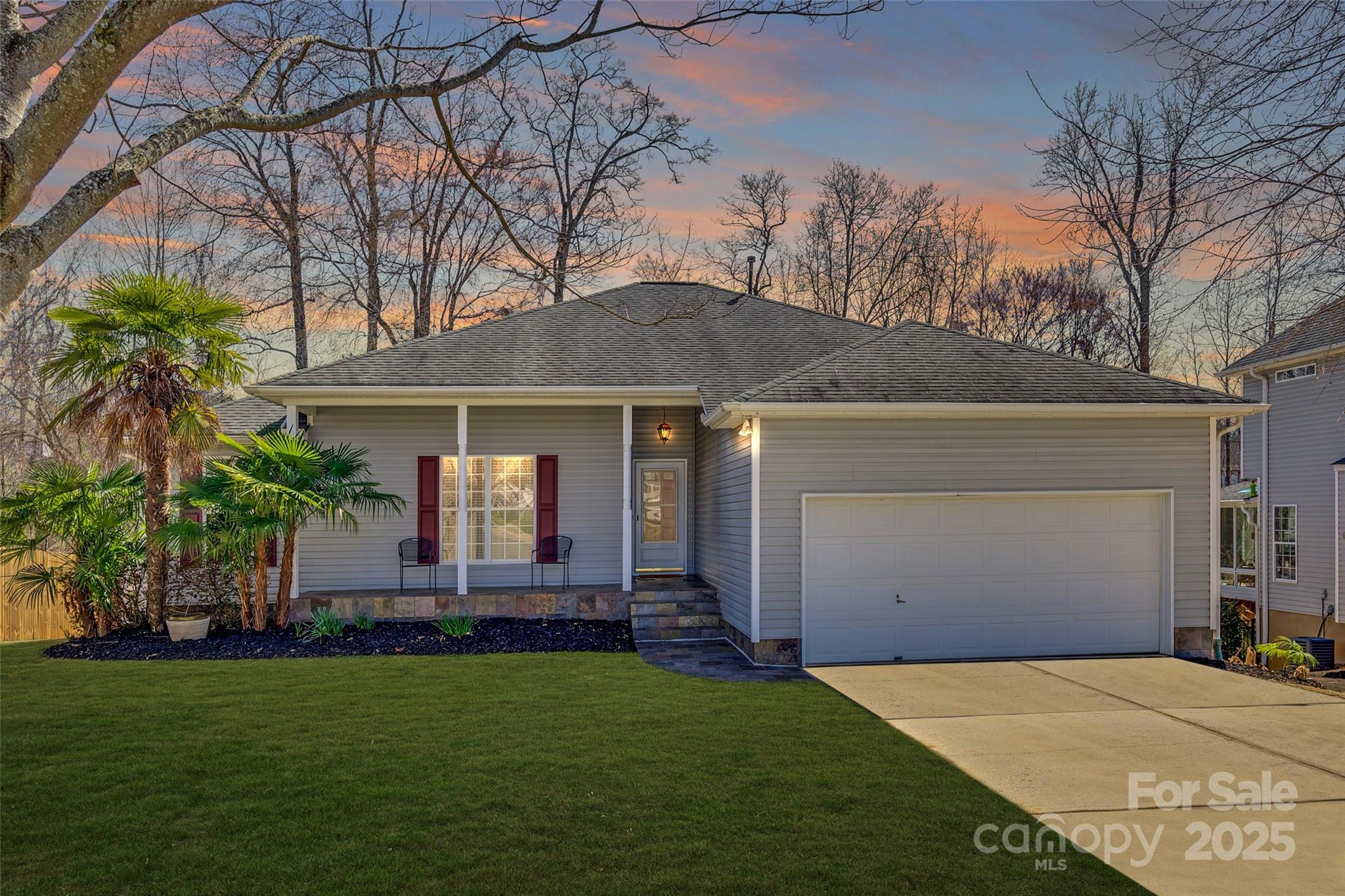 Discover the charm of this inviting three-bedroom, two-bath ranch featuring slate floors and slate countertops, a spacious living area with soaring 10-foot ceilings, and a stylish dining space. The rear deck, redone in 2020, includes a retractable awning—perfect for relaxing in the shade or sun—while the space below offers an ideal grilling area and additional room for entertaining. The large, fenced-in backyard is a private retreat with a fire pit for memorable nights under the stars. Lush landscaping surrounds the home, including banana trees, hibiscus, azaleas, dwarf peaches, and palm trees, creating a serene, tropical-inspired setting. Located in the award-winning Fort Mill School District. Sellers are including a 1-year Home Warranty.