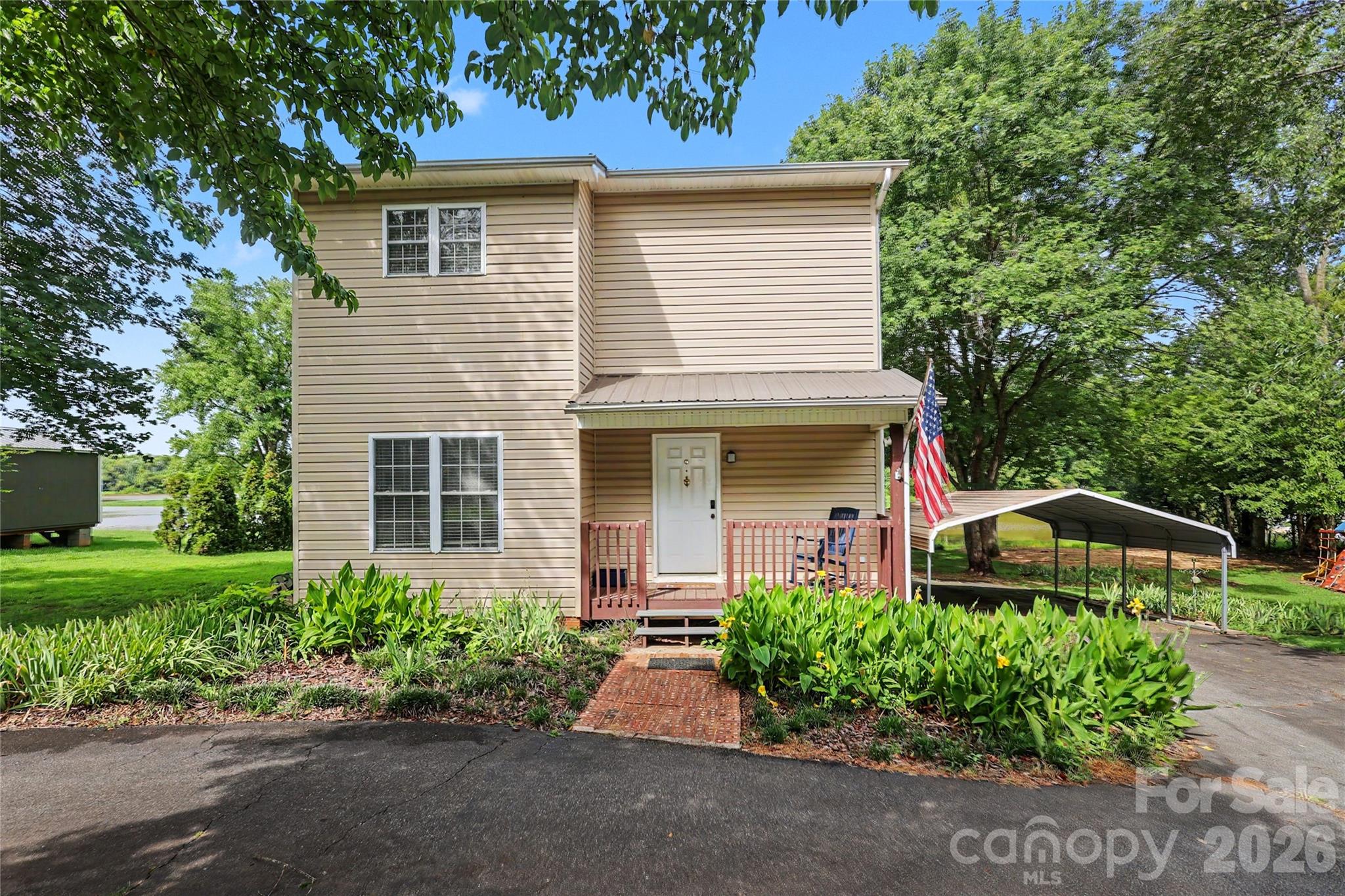 Check out this Turn-Key AirBnB property on High Rock Lake today!  This home is move in ready as a personal lake retreat or as investment property that is ready to go. There is very solid booking activity and great ratings on AirBnB and all furnishings and appliances are included (small list of exceptions attached).  The main level has great light and features a spacious great room and dining area leading out to a large deck as well as a kitchen with stainless steel appliances, a full bath, and laundry.  The upper level has 2 large bedrooms another full bath and a bonus room currently being used as a bunk room.  There is also a walk-in closet set up as a small office and a rear balcony overlooking the lake. Outside, there is a detached garage with power, circular driveway, a large carport, firepit, and a deck with a slide. The large waterfront lot is .77 acres overlooking a quiet part of the lake and a wildlife island. Buyer to verify any future install of dock/floaters with Cube. The water heater and 2nd floor balcony were replaced/updated in 2026. Virtual Tour Attached!