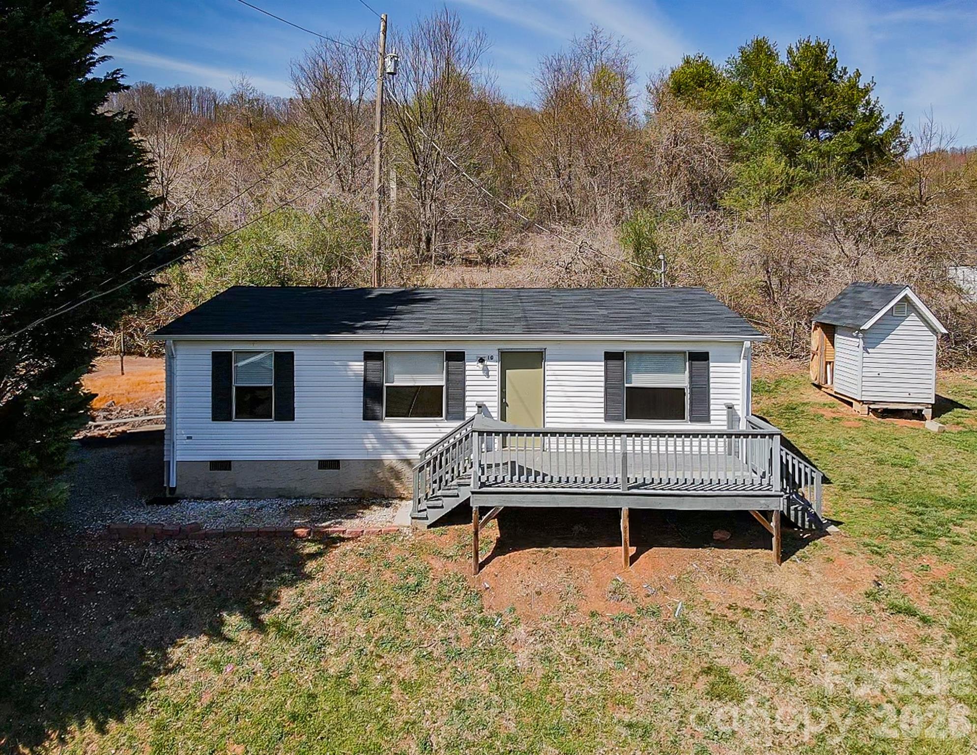 Located on a quiet private street, 10 Lands End Drive offers a fantastic opportunity for investors or buyers seeking peaceful mountain living with immediate income potential. The home has 2 bedrooms and 2 bathrooms plus a bonus room and sits on a generous 0.42-acre lot, featuring a nice flat, green yard—perfect for outdoor enjoyment, gardening, or pets.

The home includes a comfortable layout with a spacious primary suite complete with an ensuite bath and walk-in closet. Enjoy the best of outdoor living a on the large deck - an ideal spot to relax and take in the surrounding mountain setting and wildlife. A detached shed and large barn provide additional storage for tools, equipment, or hobbies.

Currently occupied by a long-term renter for $2,000/month, this property offers steady, turnkey income from day one. Whether you’re looking to expand your investment portfolio or secure a home with future flexibility, this property delivers both value and potential.

Conveniently located just 1 mile from Pisgah Highway (NC-151), you’re only 10 minutes to Candler shopping and dining and approximately 30 minutes to Asheville—combining accessibility with a peaceful, private setting.

Also available as part of a package with the neighboring home at 6 Lands End Drive (see Listing #4371930), presenting a unique opportunity to live in one and rent the other—or maximize returns by leasing both.