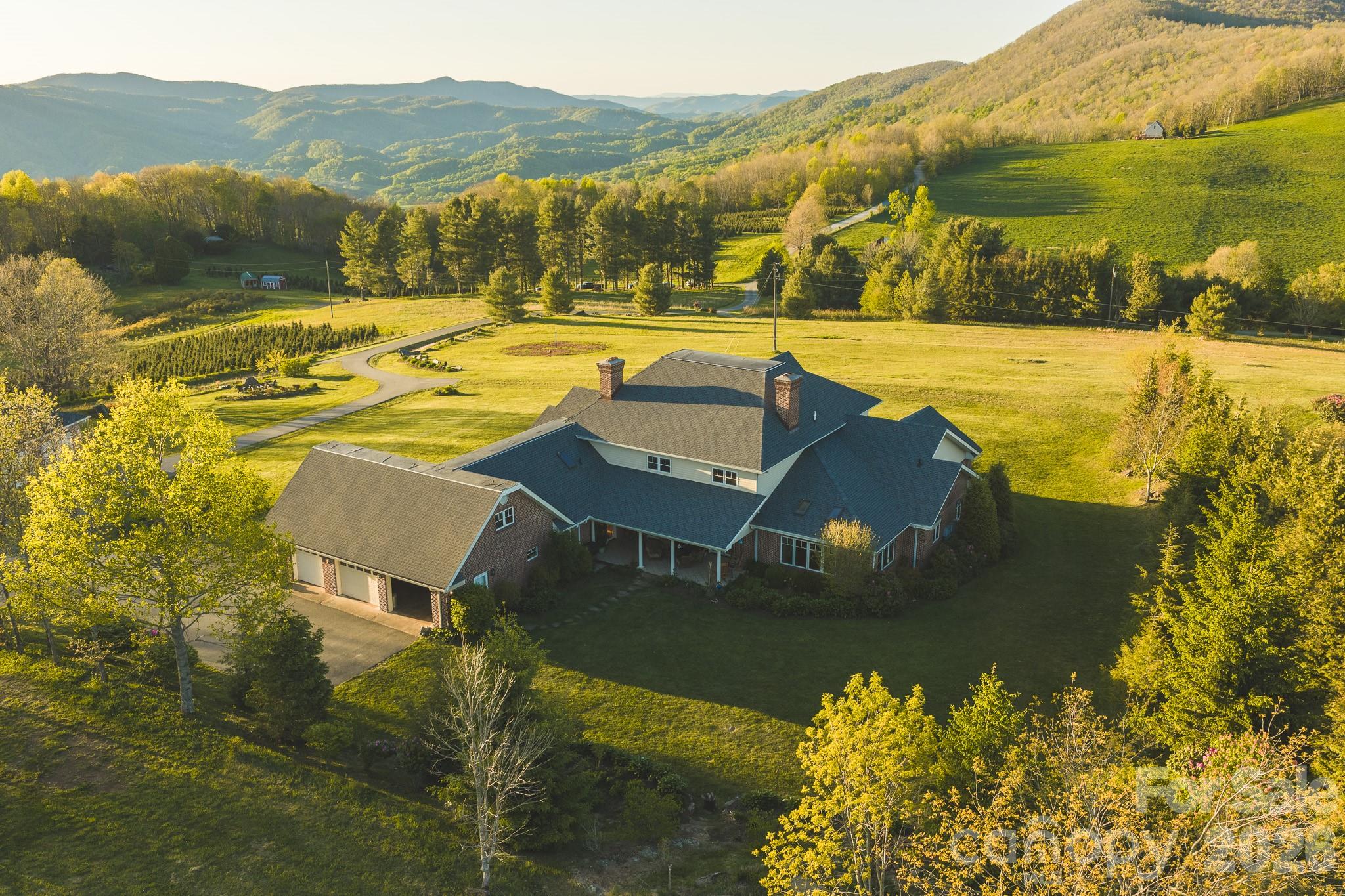 Bidding ends June 16, 2026.  Current Bid updated daily.
For sale by Online Auction with Reserve.  Price listed is current bid only and not final sales price.
Situated at over 4,000 feet elevation, this stunning home offers long-range mountain views across the High Country from a +/-6.955 acre setting of open, gently rolling pasture. With no HOA and unrestricted use, this property offers flexibility rarely found in the Boone market. This 4-bedroom, 5.5-bath home offers over 7,500 square feet of above ground heated living space designed for large-scale mountain living, multigenerational use, entertaining, or a private retreat.  New roof installed 2025!

 Inside, the home features custom maple craftsmanship throughout, including flooring, trim, cabinetry, built-ins, crown molding, and detailed woodwork. The spacious kitchen with a central island anchors multiple living and gathering spaces, while 3 fireplaces add warmth throughout the home. The primary suite includes a walk-in closet and an attached office. Multiple bonus rooms and additional office spaces provide flexibility for remote work, guest accommodations, hobbies, or expanded living needs. A standout feature is the expansive lower level, offering optimal storage capacity, recreation space, and additional utility options. Entire basement area is heated, but not included as finished living space.

Additional property highlights include:

6 garage spaces total (attached 3-car garage + detached 3-car garage)
Detached garage with its own kitchen and bath
Multiple covered decks and patios positioned to capture the mountain views
Fiber optic internet availability
Stainless steel appliances
Tankless gas water heater
Central vacuum system
Two propane HVAC systems
Brick exterior for low-maintenance ownership

Located just minutes from Downtown Boone and Appalachian State University, this property combines acreage, accessibility, unrestricted use, and mountain views in one of the High Country's most sought-after areas.

Items to convey with the sale of the home: All kitchen appliances (gas/propane range, dishwasher, refrigerator, microwave); washer and dryer; Billiard table; wine refrigerator (in Billiards room); black refrigerator in the attached garage; detached 3 car garage appliances (Electric range, refrigerator) Home inspection report and septic documents are available upon request.