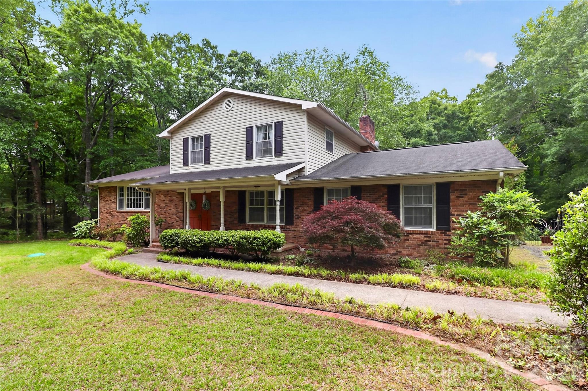 Tucked away on a beautiful wooded 4.5-acre tract just across the state line from Ballantyne, this rare Indian Land property offers endless potential in an unbeatable location. Surrounded by mature trees and natural privacy, the classic two-story home features 4 bedrooms and 3 full bathrooms with a traditional layout including formal living and dining rooms, a spacious family room, and hardwood floors throughout much of the home.

Full of character and charm, the home remains in its original condition and is ready for updates and renovation, making it an incredible opportunity for investors, renovators, or buyers looking to create their dream estate. The expansive acreage also provides a spectacular setting for building a custom luxury estate, with plenty of room for a gated entrance, pool, guest house, gardens, or additional outdoor living spaces.

Enjoy the peaceful feel of country living while being only minutes from Ballantyne’s shopping, dining, and conveniences. Hard-to-find acreage, mature trees, and unlimited possibilities make this a truly special opportunity in rapidly growing Indian Land.

Home has good bones but needs extensive updating!  Value is largely in the acreage.