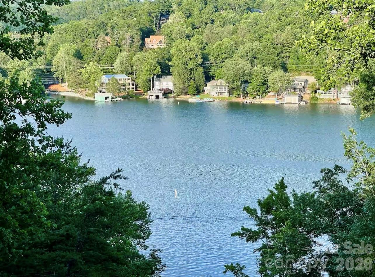 GREAT RENTAL HISTORY on this recently renovated townhome with a bright, modern and open floor plan. Gross rental income was $56,112 in 2023, $53,978 in 2024 (Helene shortened season) and $36,793 in 2025 while the lake closed. Expectations are to exceed pre-Helene numbers in 2026 with the opening of the lake!  Beautifully updated 2-bedroom, 2 bath Quail Cove Townhome with year-round lake and mountain views. Split-level floor plan with the foyer, one bedroom, and one full bath on the entry level. A few steps up to the living room, dining area and kitchen with French doors leading out to the large balcony overlooking Lake Lure and surrounding mountains. The lower level is just a few steps down from the entry level and features a laundry room, a huge 2nd bedroom, a full bath, and a private balcony overlooking the lake. The complete renovation includes new paint, luxury vinyl plank flooring, recessed lighting, bathrooms, kitchen with quartz countertops and new appliances and cabinets. Rumbling Bald amenities include 24-hour security, lake access, private beach, indoor/outdoor pools, tennis, two 18-hole championship golf courses, fitness center, spa, restaurants, bars & more!