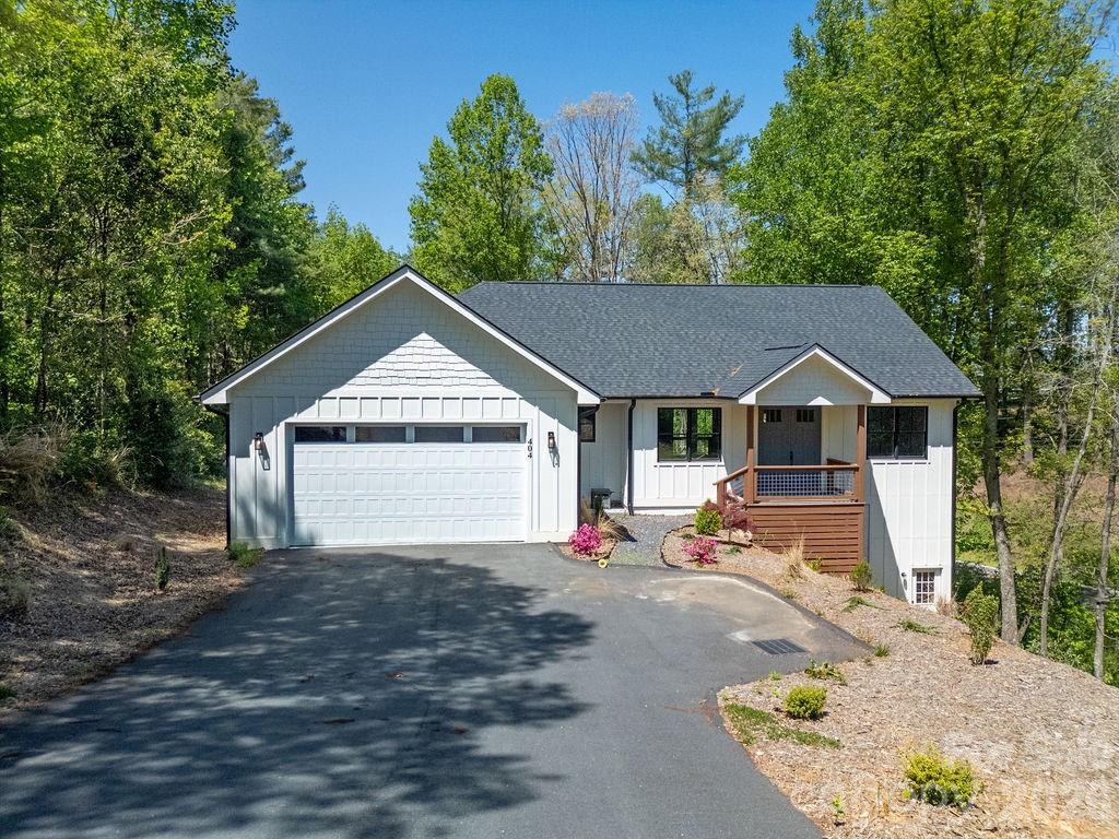 Brand-new construction located at 404 High Ridge Drive in desirable Mills River. This 3-bedroom, 2.5-bath home features a functional open floor plan with a spacious living area, abundant natural light, and seamless flow between kitchen, dining, and living spaces. The kitchen includes custom cabinetry, solid surface countertops, and ample prep space. Off the kitchen enjoy a covered back deck with composite decking. The primary suite offers a private bath with walk in shower, freestanding tub and generous closet space. Two additional bedrooms and a full bath provide flexibility for guests, office, or additional living needs. Additional highlights include an attached garage with durable epoxy flooring—ideal for easy maintenance and a clean, finished look. The home also offers a large unfinished storage area in basement, providing excellent potential for future expansion, workshop space, or abundant storage. Conveniently situated approximately 5–10 minutes from Asheville Regional Airport and within 20 minutes of downtown Asheville. Easy access to Pisgah National Forest, offering nearby hiking, biking, fishing, and outdoor recreation.