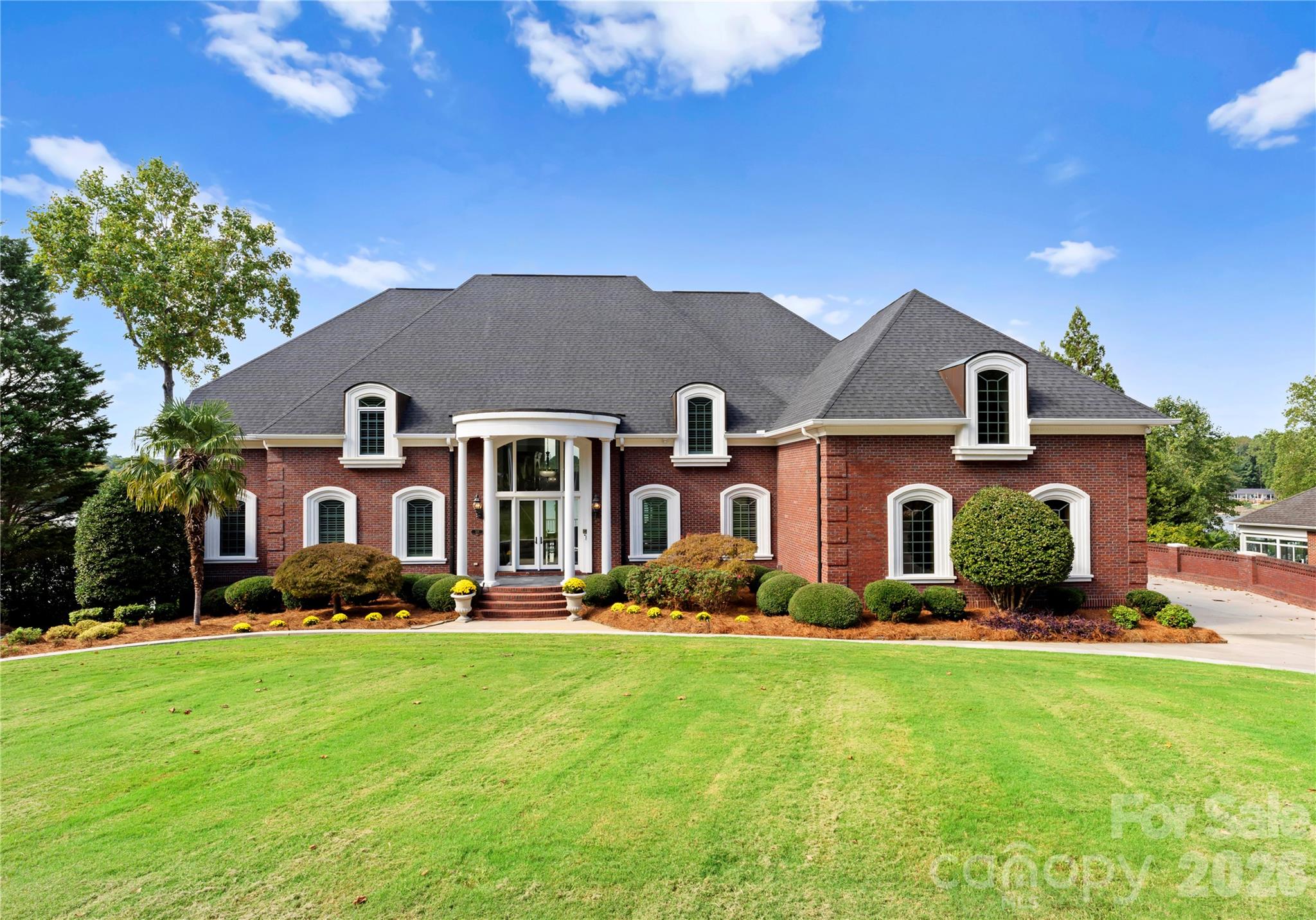 Stunning lakefront retreat offering unparalleled luxury and modern upgrades! Step into elegance with 10-foot ceilings, Marfil Marble floors accented by Emerald Pearl granite, and custom built-in cabinets throughout. The freshly painted main floor features a new double front door, upscale lighting, and an office with custom cabinetry. The primary suite impresses with a trey ceiling, crystal chandelier, surround sound, complemented by a fully remodeled bath showcasing a 5-foot ceramic shower with rain and handheld features, a large freestanding soaker tub, quartz countertops, and new ceramic tile. Entertain effortlessly with a salt pool with new vacuum and filter system, and an oversized 3-car garage boasting 24-foot ceilings, commercial gym lighting, and basketball goal. The 2nd-floor primary suite offers a kitchenette, two walk-in closets, new hardwood floors, and breathtaking views. Pool house with half bath. A true masterpiece of design and comfort—schedule your private tour today!