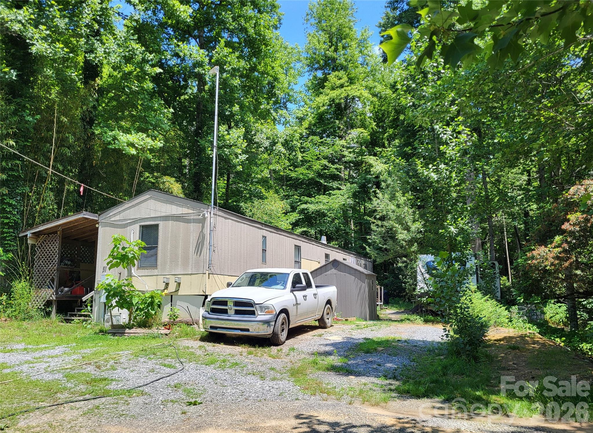 5 Acres, Black Mountain, NC., Unrestricted, 900ft Stream, Owner Financing.
Owner financing available to qualified buyers. Terms negotiable. Unrestricted, very accessible, Open Use mountain land. Black Mountain N.C. 22 miles southeast of Asheville. 5 acres with mobile home and 900 ft. stream. No HOA. Zoned Open Use (OU) 2,200'-2,400' elevation wooded Mountain terrain with over 900 feet of clear creek that runs all year. Mild winters and shady summers. Business opportunities include Airbnb, camper or tent site rentals. Has older (1996) 65-foot mobile home attached near street. Needs updating and repairs, but habitable with a full functioning kitchen and new refrigerator. Has electricity (200-amp service, Duke Energy), Starlink Wifi, water pumping station, filters and 2 mini-splits. AC-heat. 2 bathrooms, and washer and dryer. (Appliances included) No well but water is drawn year-round from the stream and filtered in the mobile home with plenty of water pressure for garden and laundry. Non-conforming septic but the home site at the top has a suitable area identified by an experienced septic installer for conventional septic. A long rough-cut access road leads to the property’s highest elevation where a clearing has been cut for a home site. A small 12'x12' eco cabin made from repurposed wood from the property is 80% complete. A large wooden deck is built into the hillside half way up.
Price includes personal property as well, to include:
2021 Kodiak 33' camper with 2 slides for temporary/full time living quarters.
2021 John Deere 1025R Tractor with front Loader and Backhoe. (Has 2 types of brush fork attachments. Only 379 hours. Runs perfect- all scheduled maintenance performed.)
2019 19' Ozark Toy-Hauler camper that is set up in a large clearing near the creek. (Rentable April-November)
2021 Polaris Ranger 4x4 in perfect operating condition.
2 Ego Electric chainsaws with batteries and chargers.
Starlink Wifi equipment with 30 ft. custom mast.
4 year old 15hp chipper.
2 generators with easy hookup to camper or mobile home.
2 Fire rings for campfires. Numerous saws, spare pumps, shovels, etc. stored on shelving in the mobile home’s mudroom.
Extra items are negotiable but a package deal is preferred.
This 5-acre property is wooded with tall mature trees, rhododendron and plenty of Mountain Laurel. Clean creek water runs all year for possible hydropower setup. About 17 residents live on this 2-mile rural, quiet, private residential, paved road. Newly built, beautiful mountain homes up the road contribute to the gentrification and property value. This property is situated in the fold of the mountains and keeps you protected from winter winds and summer sun. Early sunsets behind the mountain means temperatures cool off early for comfortable open-window sleeping weather. Nature's fresh air and a babbling creek promote simple stress-free mountain living. Town, groceries and shopping 11 miles away. A preppers dream. By adding additional solar panels to the 8 already on site, other sections of this property could easily be off-grid. Possible set-up for homesteading. At buyer's request, seller can remain on property until buyer is familiarized with all the equipment.
The property foundation type is concrete.